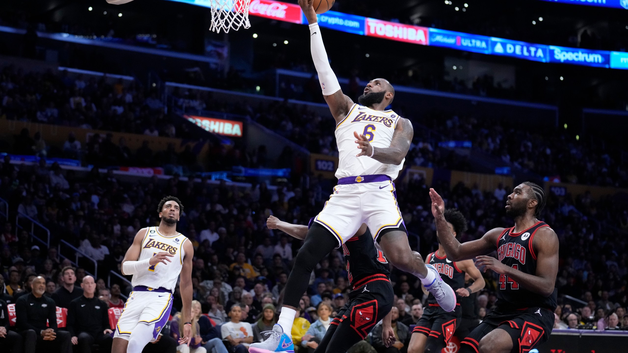 Los Angeles Lakers forward LeBron James (6) scores past Chicago Bulls forward Patrick Williams during the second half of an NBA basketball game, Sunday, March 26, 2023, in Los Angeles. (AP Photo/Marcio Jose Sanchez)