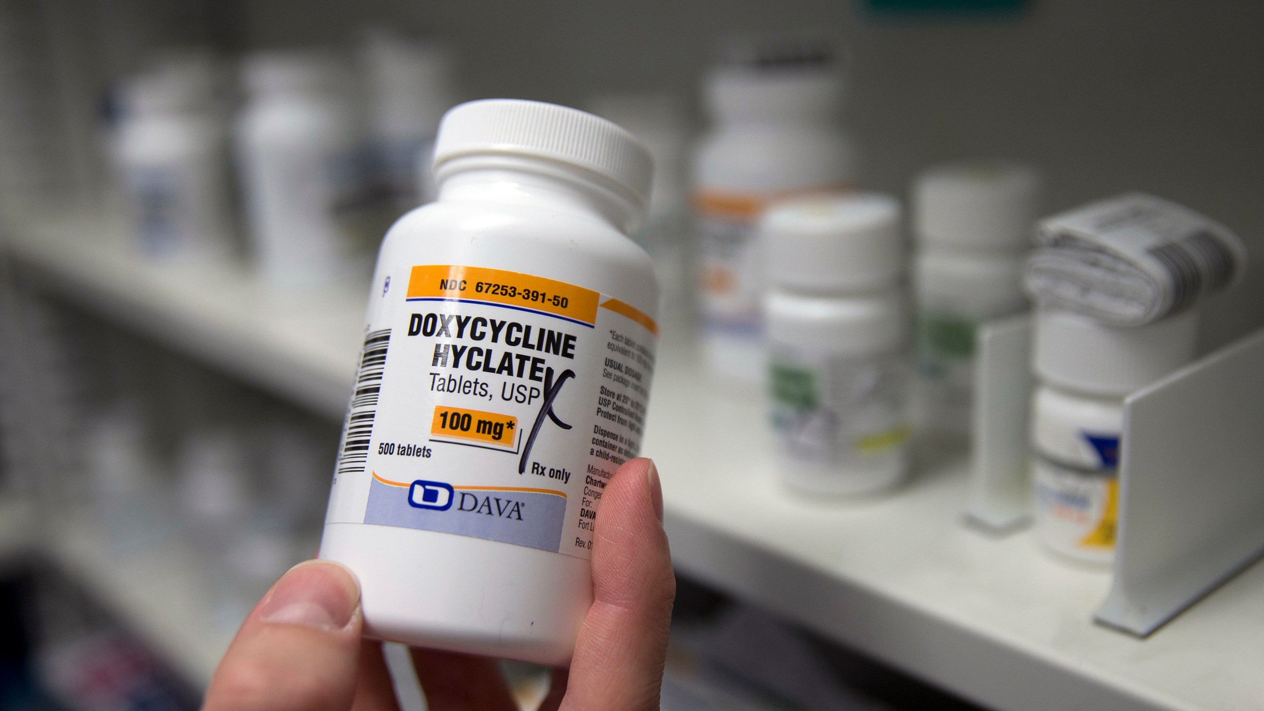 FILE - A pharmacist holds a bottle of the antibiotic doxycycline hyclate in Sacramento, Calif., July 8, 2016. On Tuesday, April 11, 2023, the Centers for Disease Control and Prevention released data about some of the most common infectious diseases in the U.S. The numbers show how chlamydia, gonorrhea and syphilis infections have been accelerating across the country. Meanwhile, the CDC is considering recommending the antibiotic doxycycline to be used after sex to prevent those infections. (AP Photo/Rich Pedroncelli, File)