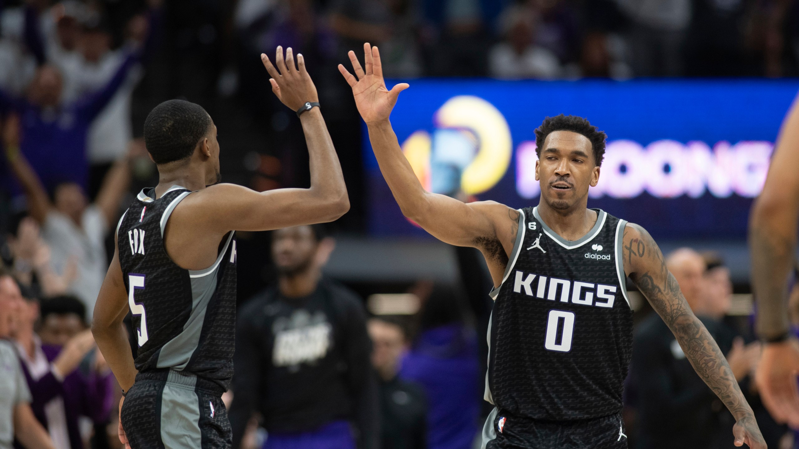 Sacramento Kings guards De'Aaron Fox (5) and Malik Monk (0) celebrate in the third quarter during Game 1 against the Golden Sate Warriors in the first round of the NBA basketball playoffs in Sacramento, Calif., Saturday, April 15, 2023. The Kings won 126 - 123. (AP Photo/José Luis Villegas)