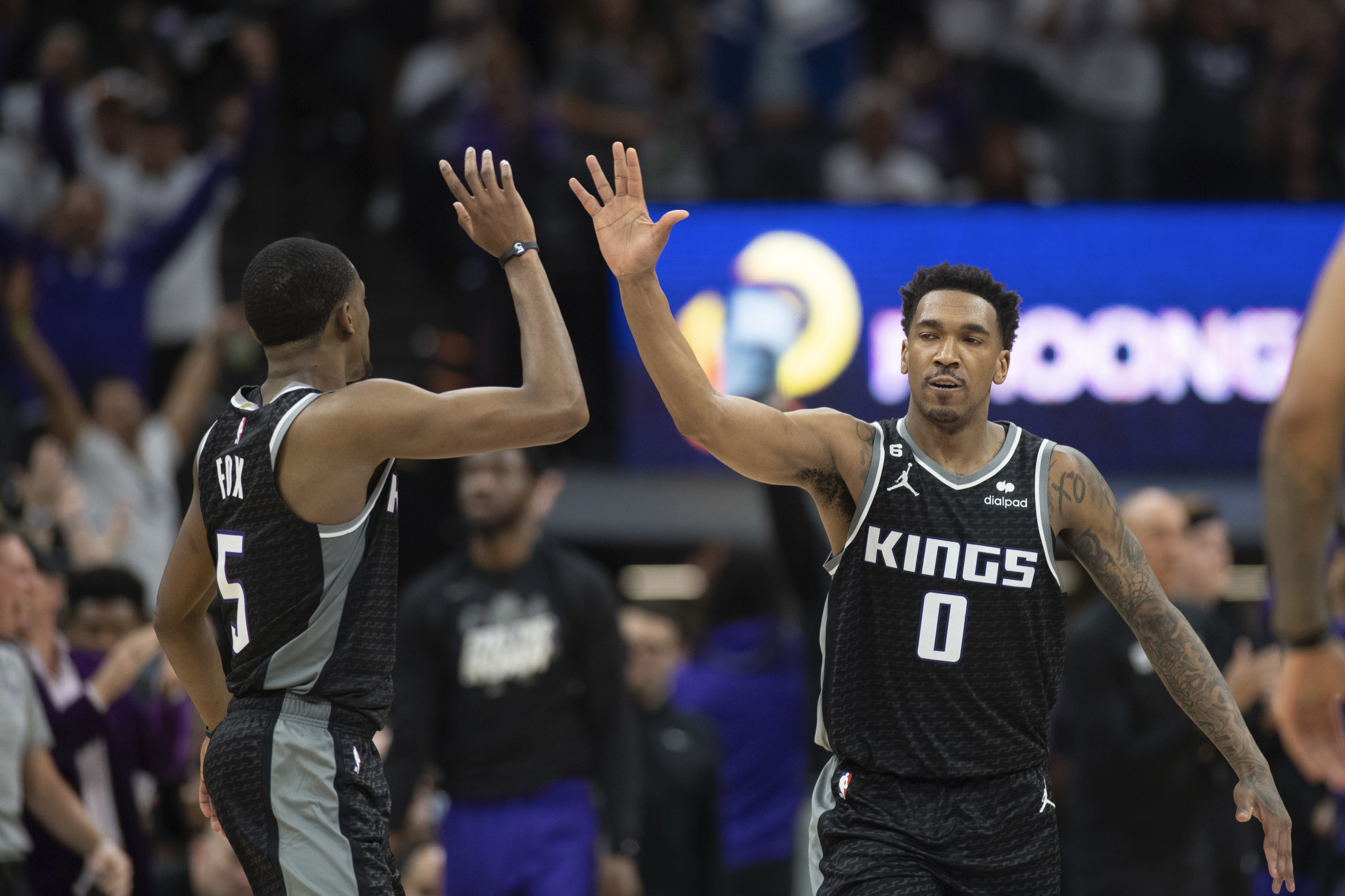 Sacramento Kings guards De'Aaron Fox (5) and Malik Monk (0) celebrate in the third quarter during Game 1 against the Golden Sate Warriors in the first round of the NBA basketball playoffs in Sacramento, Calif., Saturday, April 15, 2023. The Kings won 126 - 123. (AP Photo/José Luis Villegas)