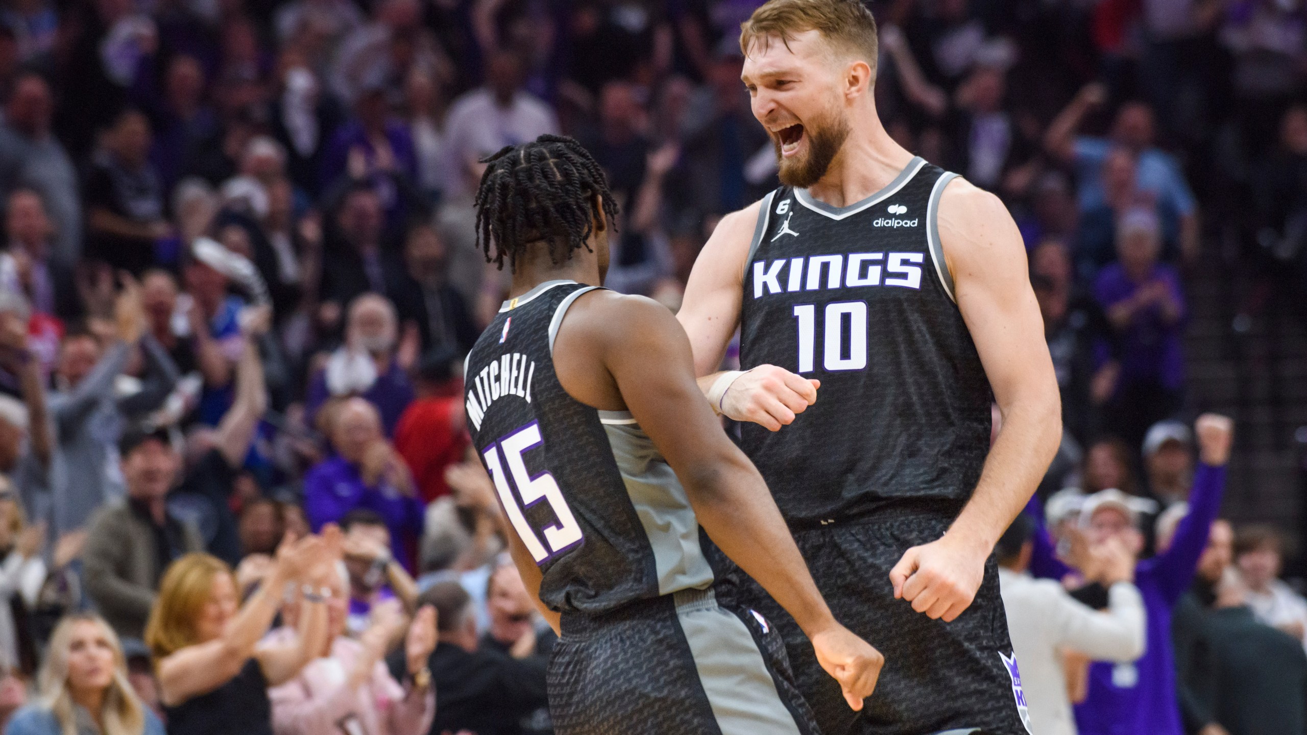 Sacramento Kings forward Domantas Sabonis (10) congratulates guard Davion Mitchell (15) in the first half during Game 1 in the first round of the NBA basketball playoffs against the Golden State Warriors in Sacramento, Calif., Monday, April 17, 2023. (AP Photo/Randall Benton)