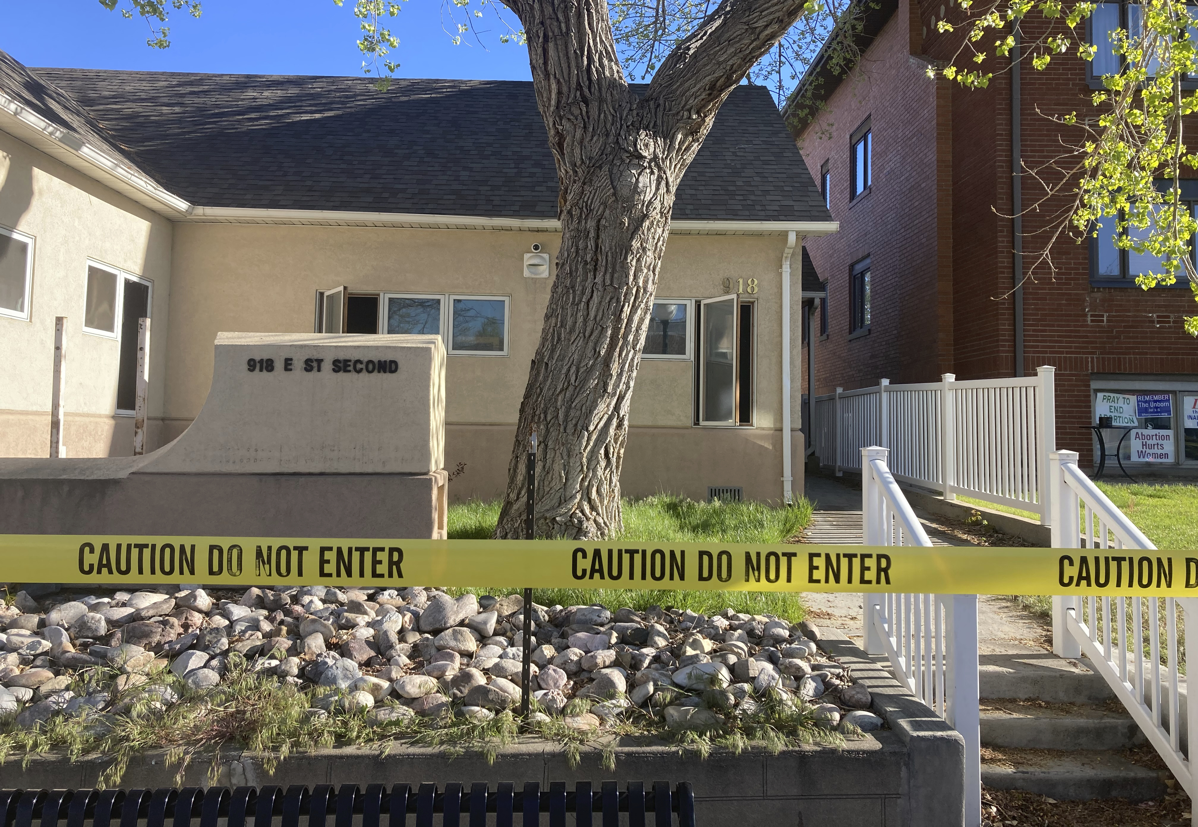 FILE - The fire-damaged Wellspring Health Access clinic is cordoned by tape on May 25, 2022, in in Casper, Wyo. Wyoming’s first full-service abortion clinic in years defiantly opened Thursday, April, 20, 2023, nearly one year after an arson attack ravaged it and despite looming laws that could shut it down with some of the toughest abortion restrictions in the U.S. (AP Photo/Mead Gruver, File)