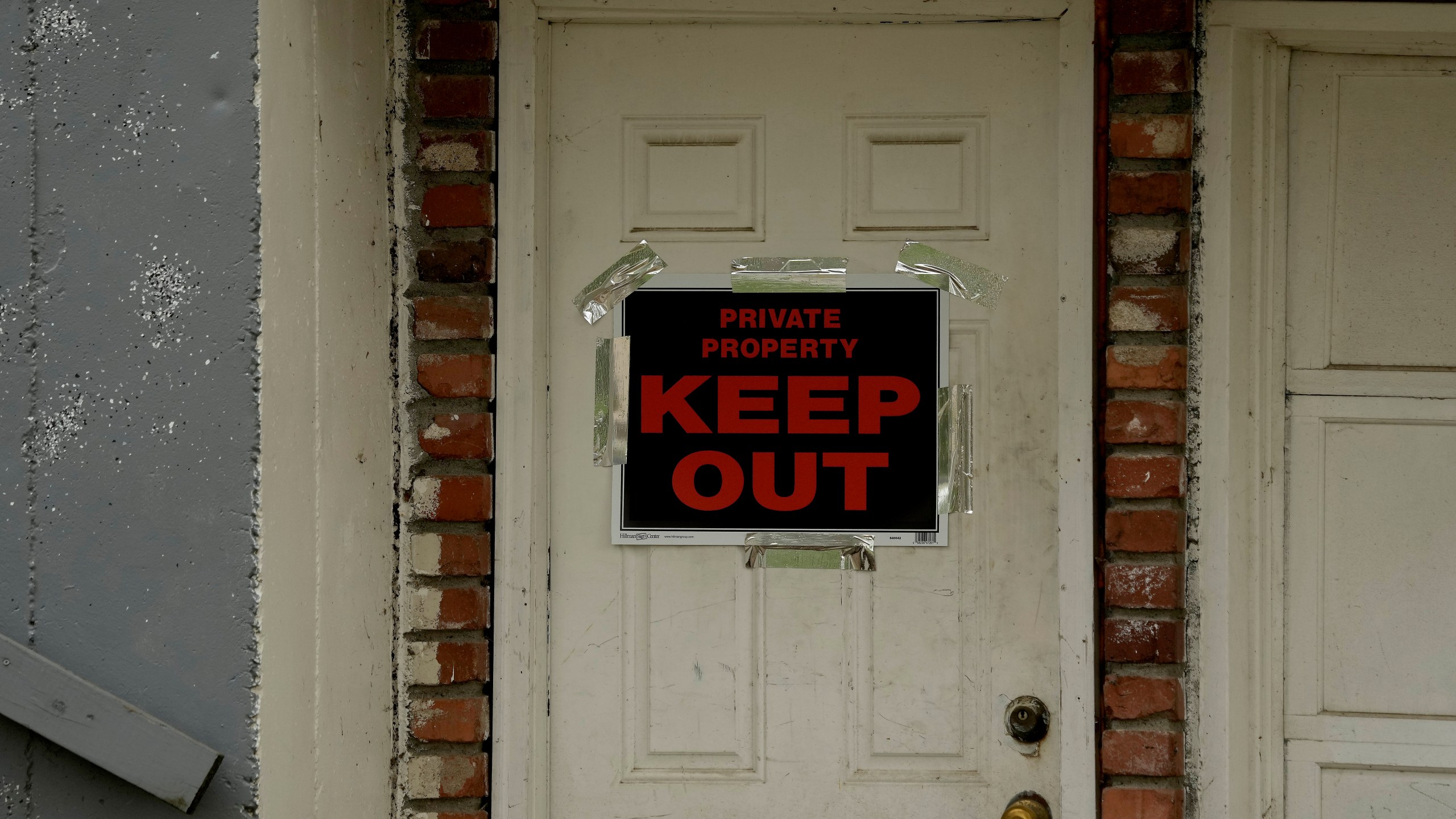 FILE - A keep out sign is posted on a home, Wednesday, April 19, 2023, near the house where 84-year-old Andrew Lester shot 16-year-old Ralph Yarl a week earlier in Kansas City, Mo. (AP Photo/Charlie Riedel, File)