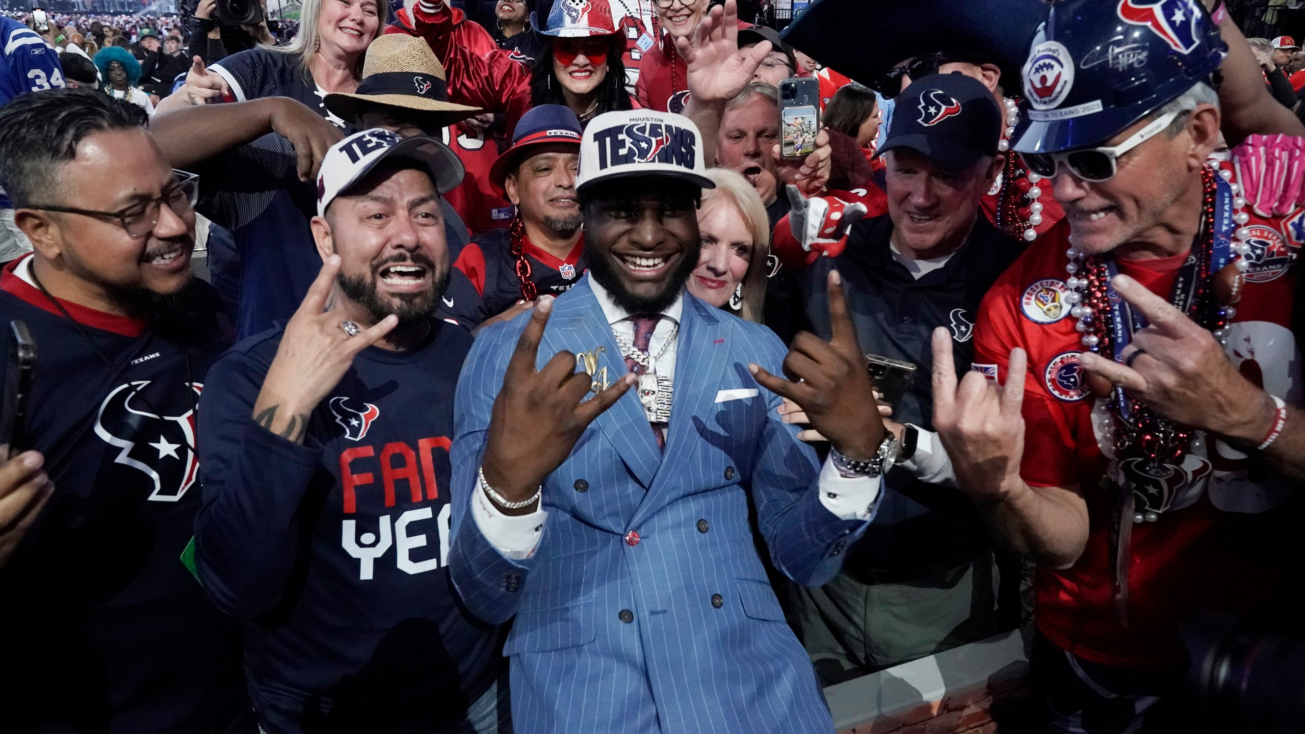 Alabama linebacker Will Anderson Jr. celebrates with fans after being chosen by the Houston Texans with the third overall pick during the first round of the NFL football draft, Thursday, April 27, 2023, in Kansas City, Mo. (AP Photo/Charlie Riedel)