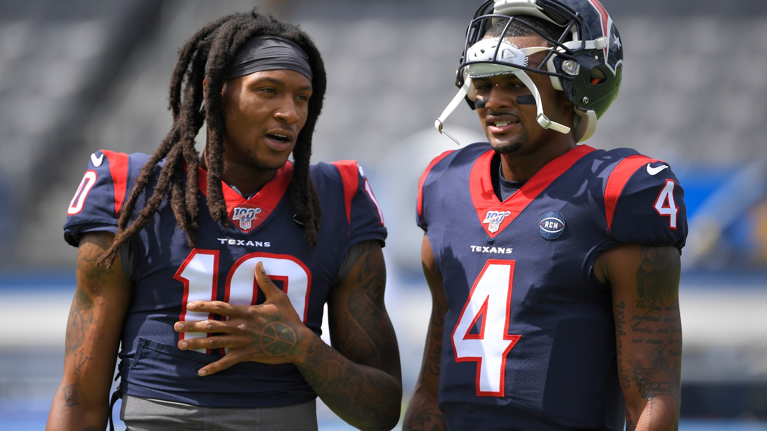 FILE - Houston Texans wide receiver DeAndre Hopkins. left, talks with quarterback Deshaun Watson before an NFL football game against the Los Angeles Chargers Sunday, Sept. 22, 2019, in Carson, Calif. Watson , now with the Cleveland Browns, said Tuesday, May 30, 2023, that he has spoken to Hopkins, his close friend and former Houston teammate, and encouraged the five-time Pro Bowl wide receiver to consider a reunion. Hopkins is a free agent after the Arizona Cardinals released him last week. (AP Photo/Mark J. Terrill, File)