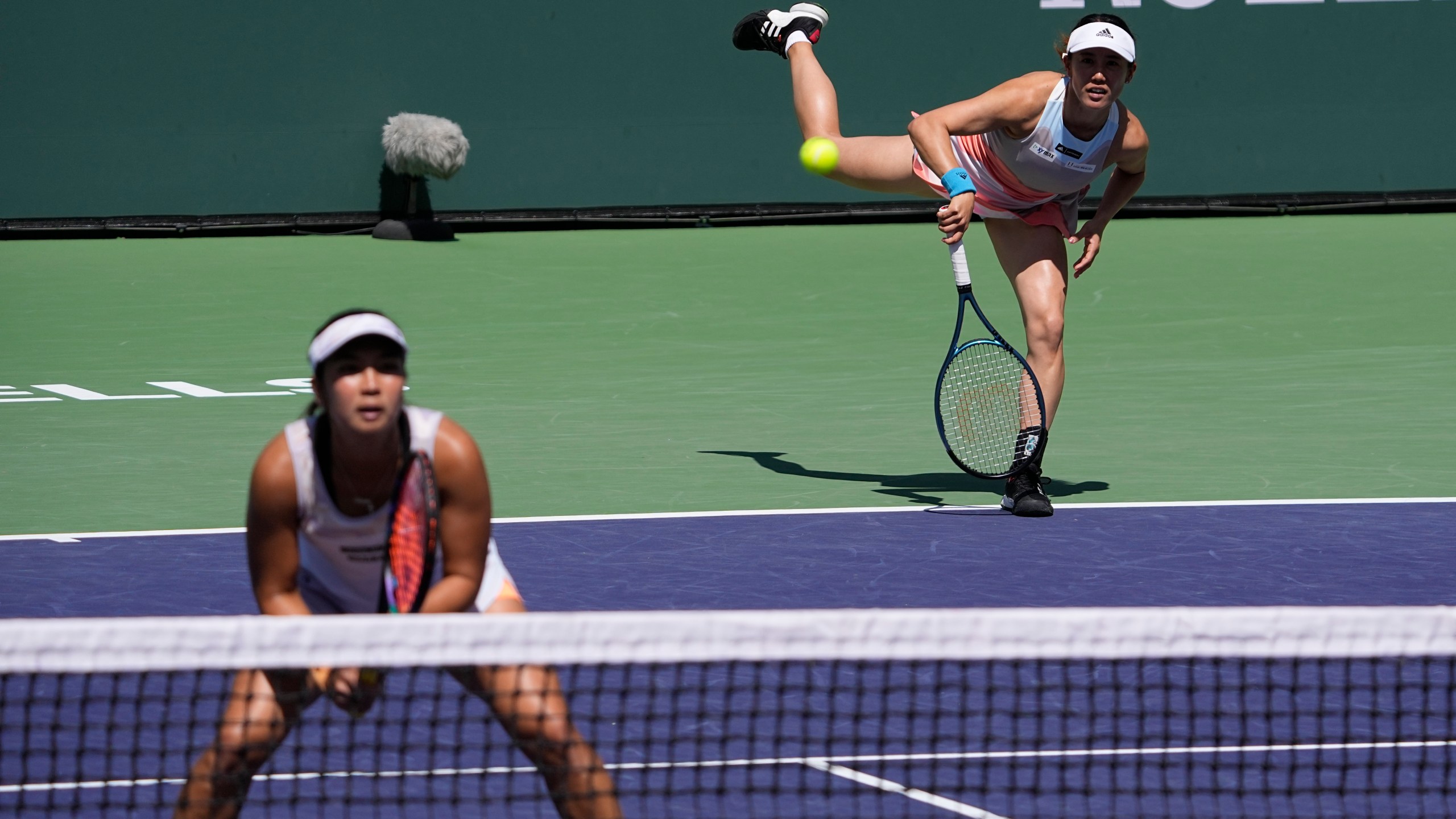 FILE - Miyu Kato, of Japan, right, serves behind her partner Aldila Sutjiadi, of Indonesia, as they play against Beatriz Haddad Maia, of Brazil, and Laura Siegemund, of Germany, in a doubles semifinal match at the BNP Paribas Open tennis tournament Friday, March 17, 2023, in Indian Wells, Calif. French Open doubles player Miyu Kato and her partner Aldila Sutjiadi have been forced to forfeit a match when Kato accidentally hit a ball girl in the neck with a ball after a point during their match against Marie Bouzkova and Sara Sorribes Tormo on Sunday, June 4, 2023. (AP Photo/Mark J. Terrill, File)