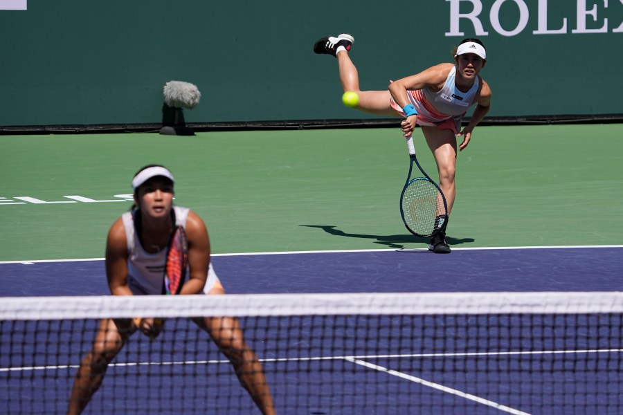 FILE - Miyu Kato, of Japan, right, serves behind her partner Aldila Sutjiadi, of Indonesia, as they play against Beatriz Haddad Maia, of Brazil, and Laura Siegemund, of Germany, in a doubles semifinal match at the BNP Paribas Open tennis tournament Friday, March 17, 2023, in Indian Wells, Calif. French Open doubles player Miyu Kato and her partner Aldila Sutjiadi have been forced to forfeit a match when Kato accidentally hit a ball girl in the neck with a ball after a point during their match against Marie Bouzkova and Sara Sorribes Tormo on Sunday, June 4, 2023. (AP Photo/Mark J. Terrill, File)