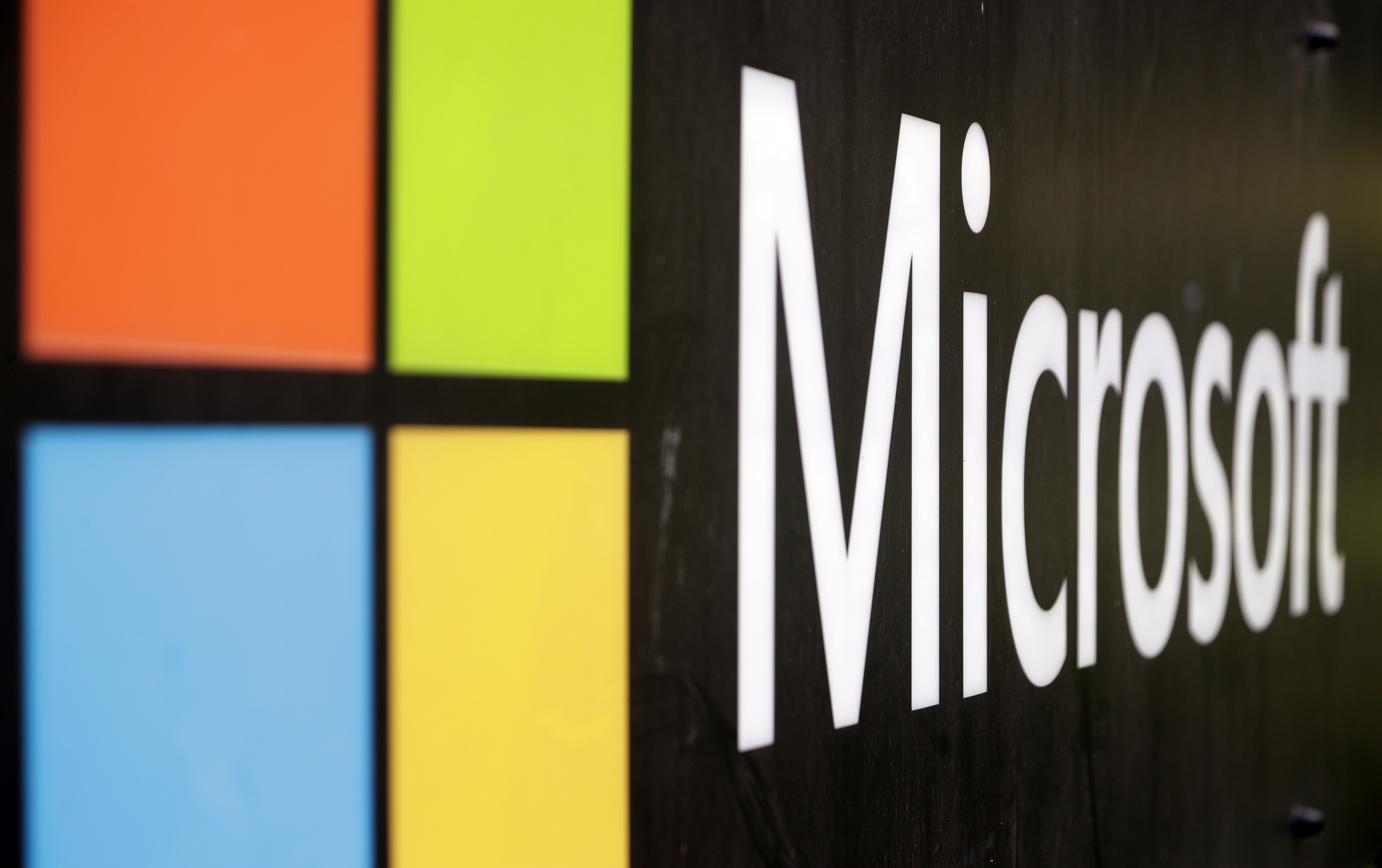 FILE - The Microsoft company logo is displayed at their offices in Sydney, Australia, on Feb. 3, 2021. Microsoft says the early June 2023 disruptions to its Microsoft’s flagship office suite — including the Outlook email and OneDrive file-sharing apps — were denial-of-service attacks by a shadowy new hacktivist group. (AP Photo/Rick Rycroft, File)