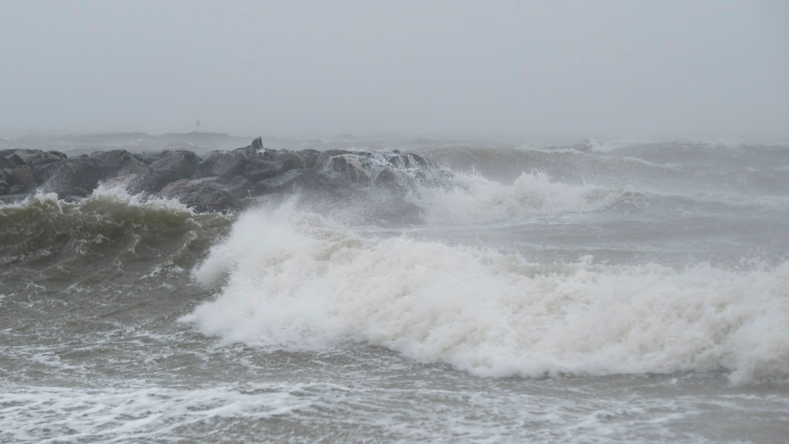 FILE - Waves crash at Outlook Beach in Hampton, Va., Sept. 30, 2022. Storms with strong gusting winds sometimes cause a phenomenon known as a meteotsunami, in which the winds push on the water and increase the wave height near the coast before it eventually crashes onto shore. (Billy Schuerman/The Virginian-Pilot via AP, File)