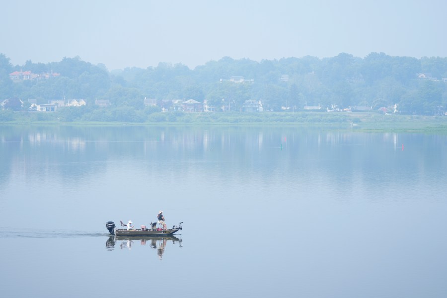 People fish on the Susquehanna River amidst haze from Canadian wildfires, Thursday, June 29, 2023, in Harrisburg, Pa. (AP Photo/Matt Rourke)