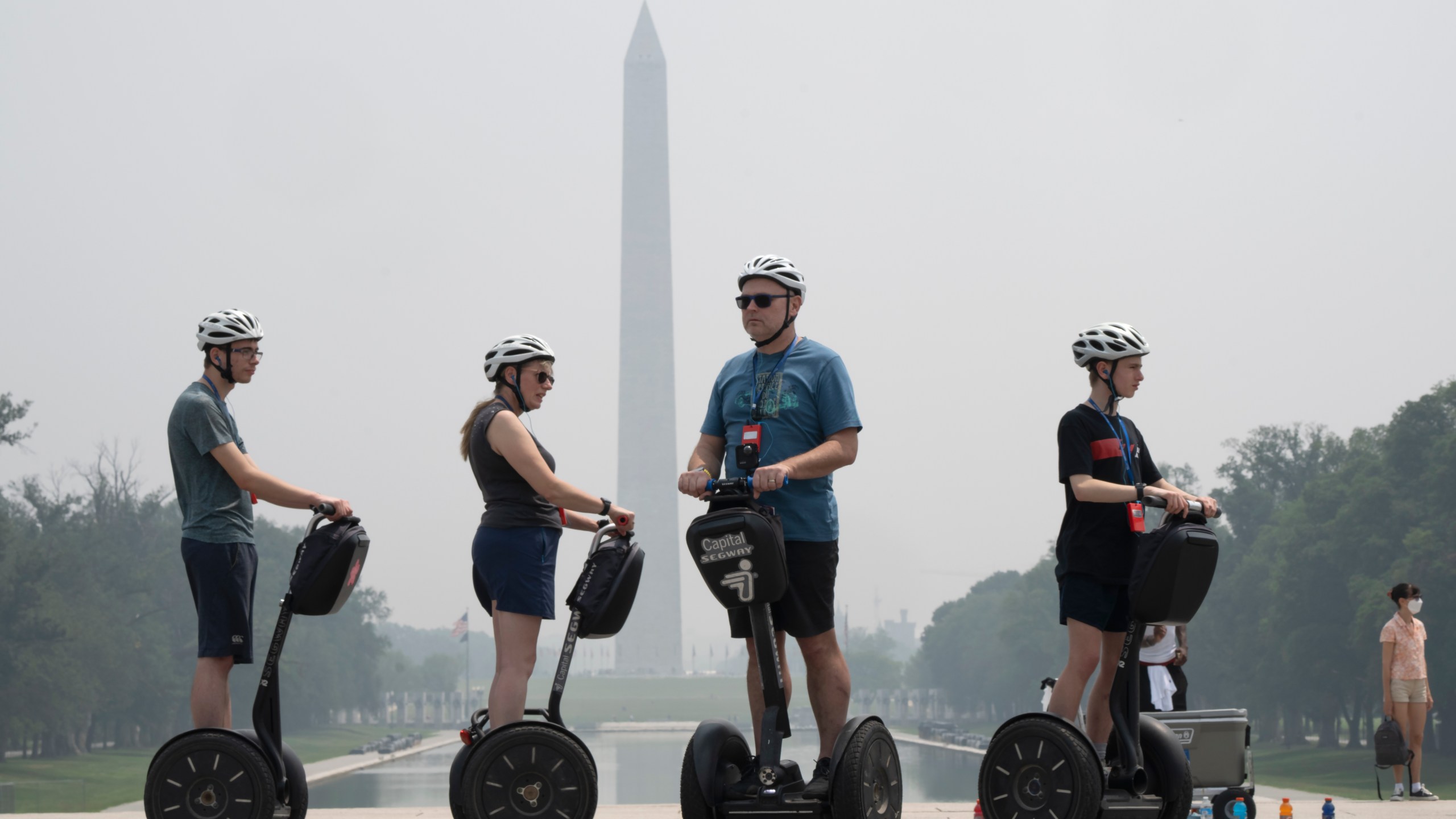 Tourists on Segways visit the Lincoln Memorial while the sky is hazy with smoke from wildfires in Canada, obscuring the view of the Capitol and other buildings along the National Mall almost completely past the Washington Monument, Thursday, June 29, 2023, in Washington. (AP Photo/Jacquelyn Martin)