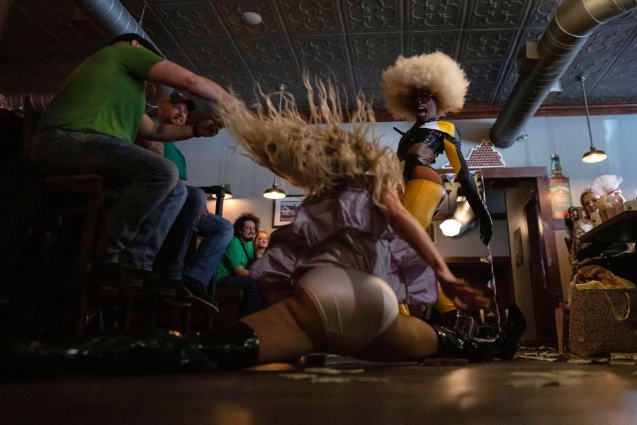 Javon Love, right, performs with Baby Angel, doing the splits, during "Mimosas & Heels Drag Brunch" at the Public House, Sunday, March 5, 2023, in Norfolk, Va. The drag bunch was hosted by Harpy Daniels and Javon Love. (AP Photo/Carolyn Kaster)