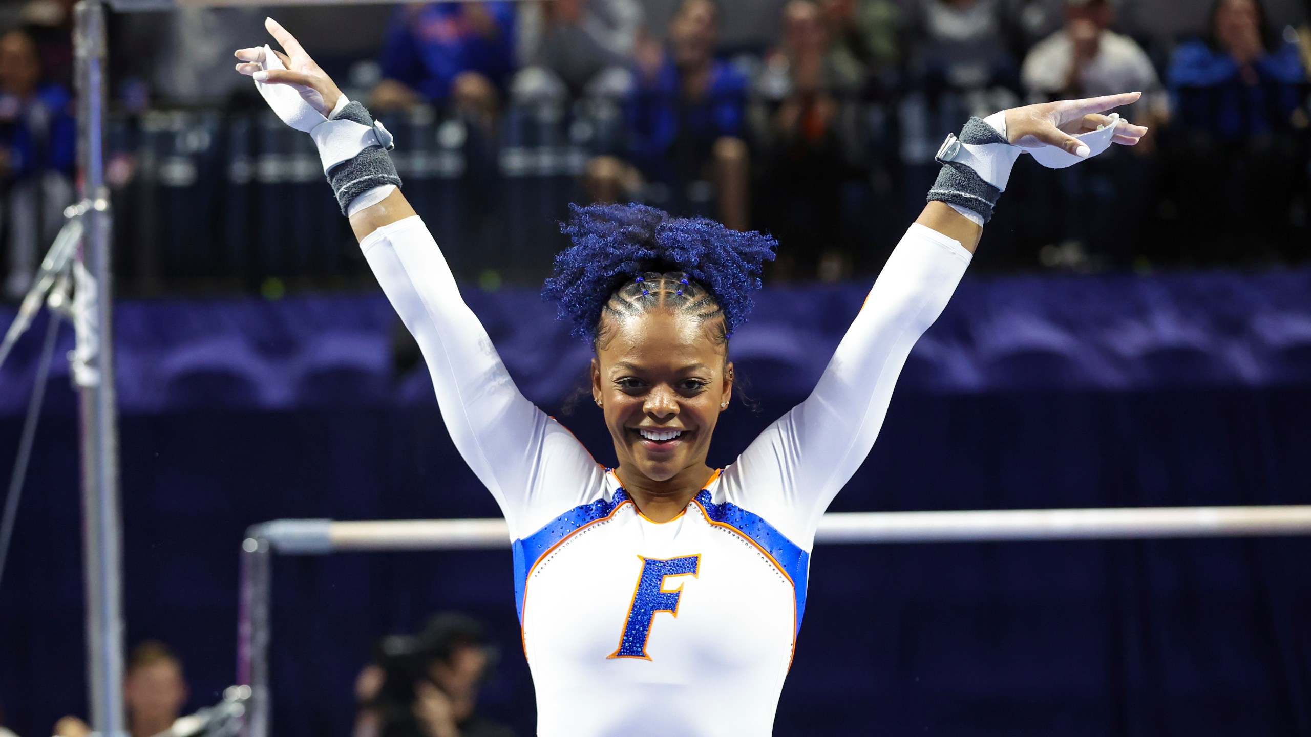 FILE - Florida's Trinity Thomas reacts after competing on the uneven bars during an NCAA gymnastics meet against Georgia on Friday, Jan. 27, 2023, in Gainesville, Fla. Thomas, the 2022 NCAA champion while competing for Florida, says she is going to make a bid for the 2024 U.S. women's Olympic gymnastics team. (AP Photo/Gary McCullough, File)