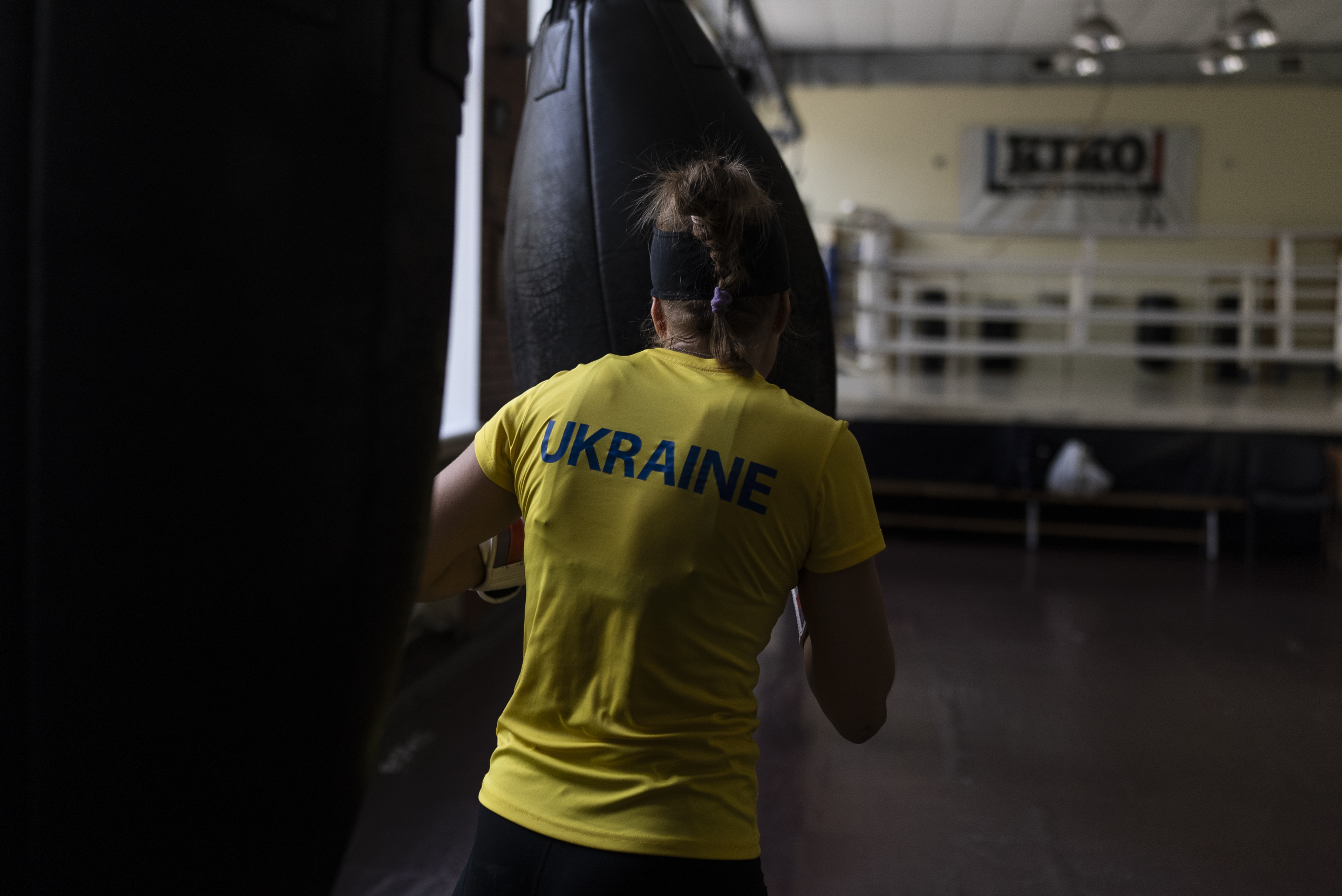 Ukrainian boxer Anna Lysenko hits a punching bag, during her training at Kiko Boxing Club in Kyiv, Ukraine, Thursday, July 6, 2023. Lysenko dedicates long hours preparing for next year's Paris Olympics despite the unsettling sounds of explosions booming outside. (AP Photo/Jae C. Hong)