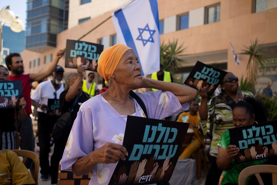 Members of the Hebrew Israelite community rally outside of the District Court in Beersheba, Israel, ahead of a hearing on the deportation orders for dozens from their community, Wednesday, July 19, 2023. The community's decades-long plight to secure their status shines a light on Israel's strict immigration policy, which grants people whom it considers Jewish automatic citizenship but limits entry to others who don't fall within that definition. (AP Photo/Maya Alleruzzo)