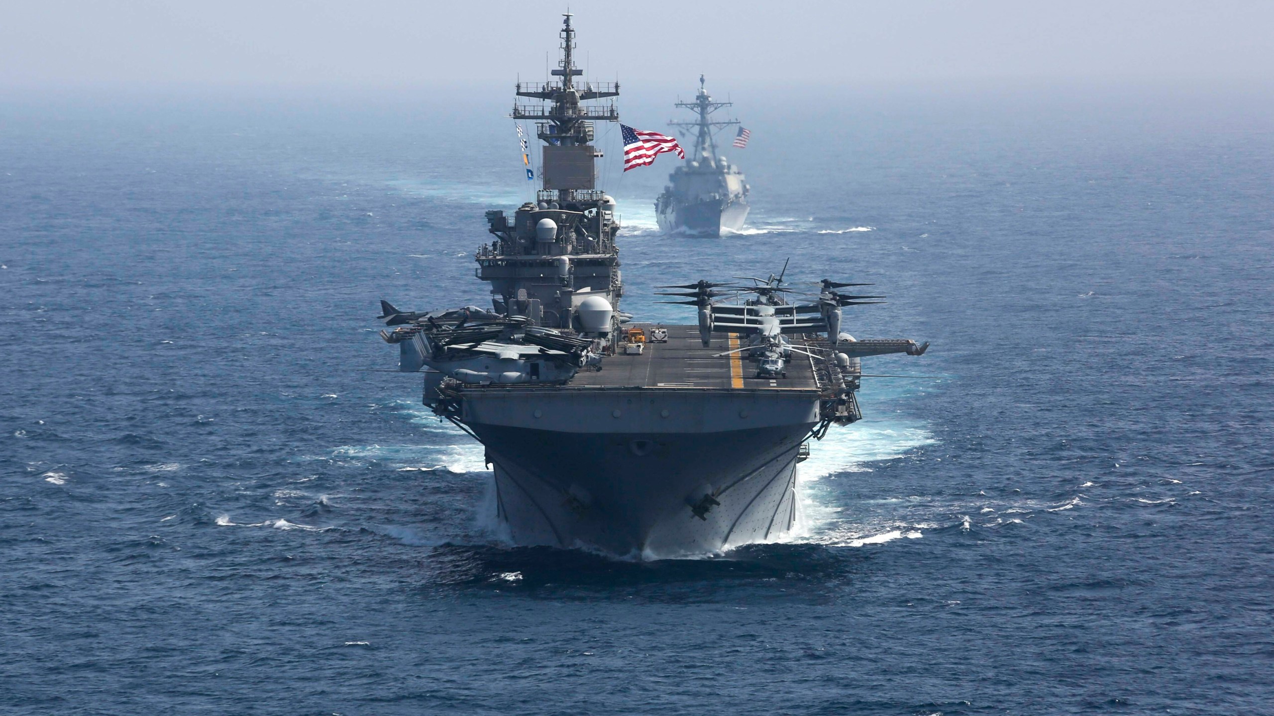 FILE - In this photo released by the U.S. Navy, the amphibious assault ship USS Kearsarge and the Arleigh Burke-class guided-missile destroyer USS Bainbridge sail in formation as part of the USS Abraham Lincoln aircraft carrier strike group in the Arabian Sea. President Joe Biden has chosen Adm. Lisa Franchetti to lead the Navy, a senior administration official said Friday, July 21, 2023. If confirmed, she would be the first woman to be a U.S. military service chief. (Mass Communication Specialist 1st Class Brian M. Wilbur, U.S. Navy via AP, File)