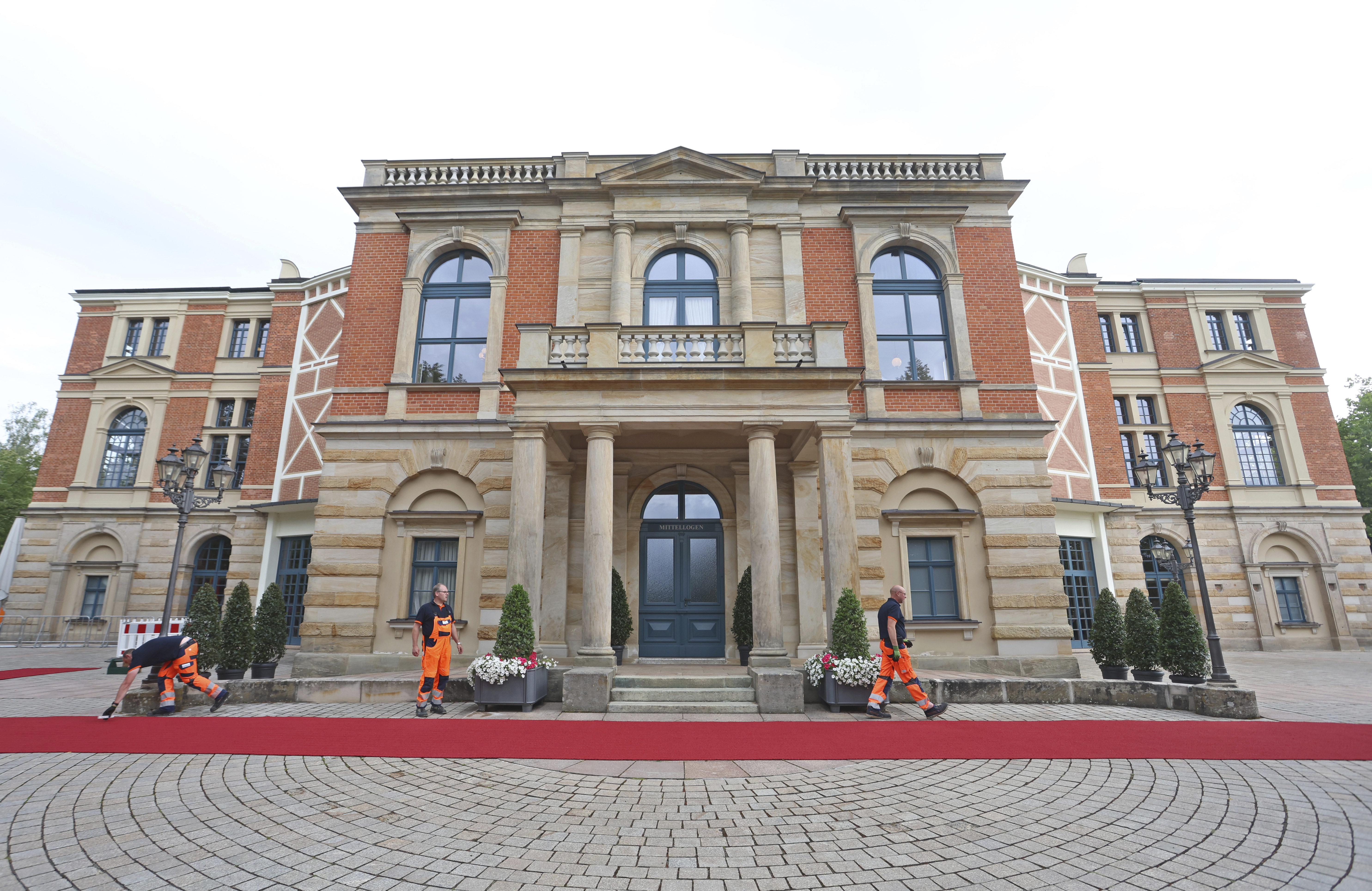 The red carpet is fixed in front of the Festspielhaus for the opening of the Bayreuth Richard Wagner Festival in Bayreuth, Germany, Tuesday July 25, 2023. (Karl-Josef Hildenbrand/dpa via AP)