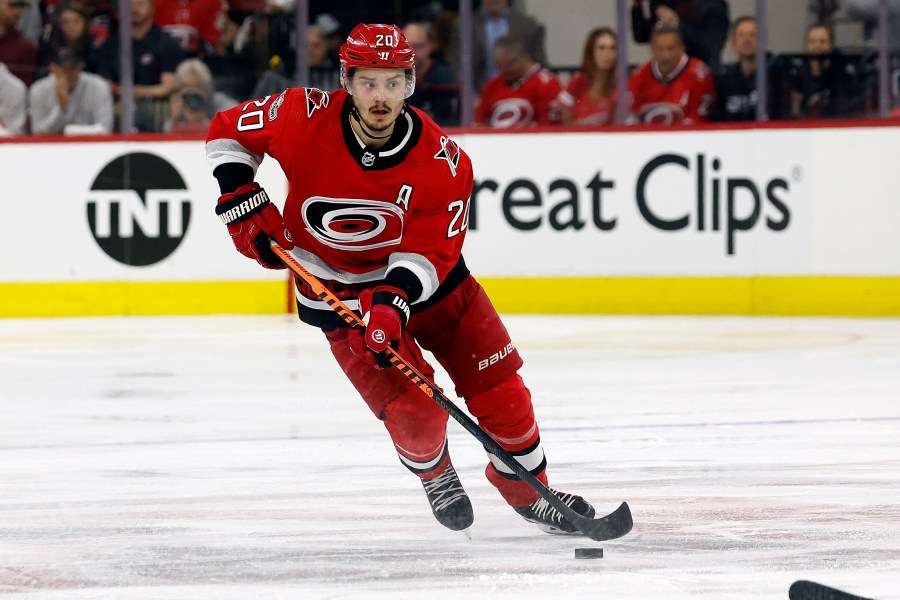 FILE - Carolina Hurricanes' Sebastian Aho (20) skates with the puck against the Florida Panthers during the second period of Game 2 of the NHL hockey Stanley Cup Eastern Conference finals in Raleigh, N.C., Saturday, May 20, 2023. Sebastian Aho is staying with the Carolina Hurricanes through his prime after signing an eight-year contract extension worth $78 million. The team on Wednesday, July 26, announced the deal, which goes into effect for the 2024-25 NHL season.(AP Photo/Karl B DeBlaker)