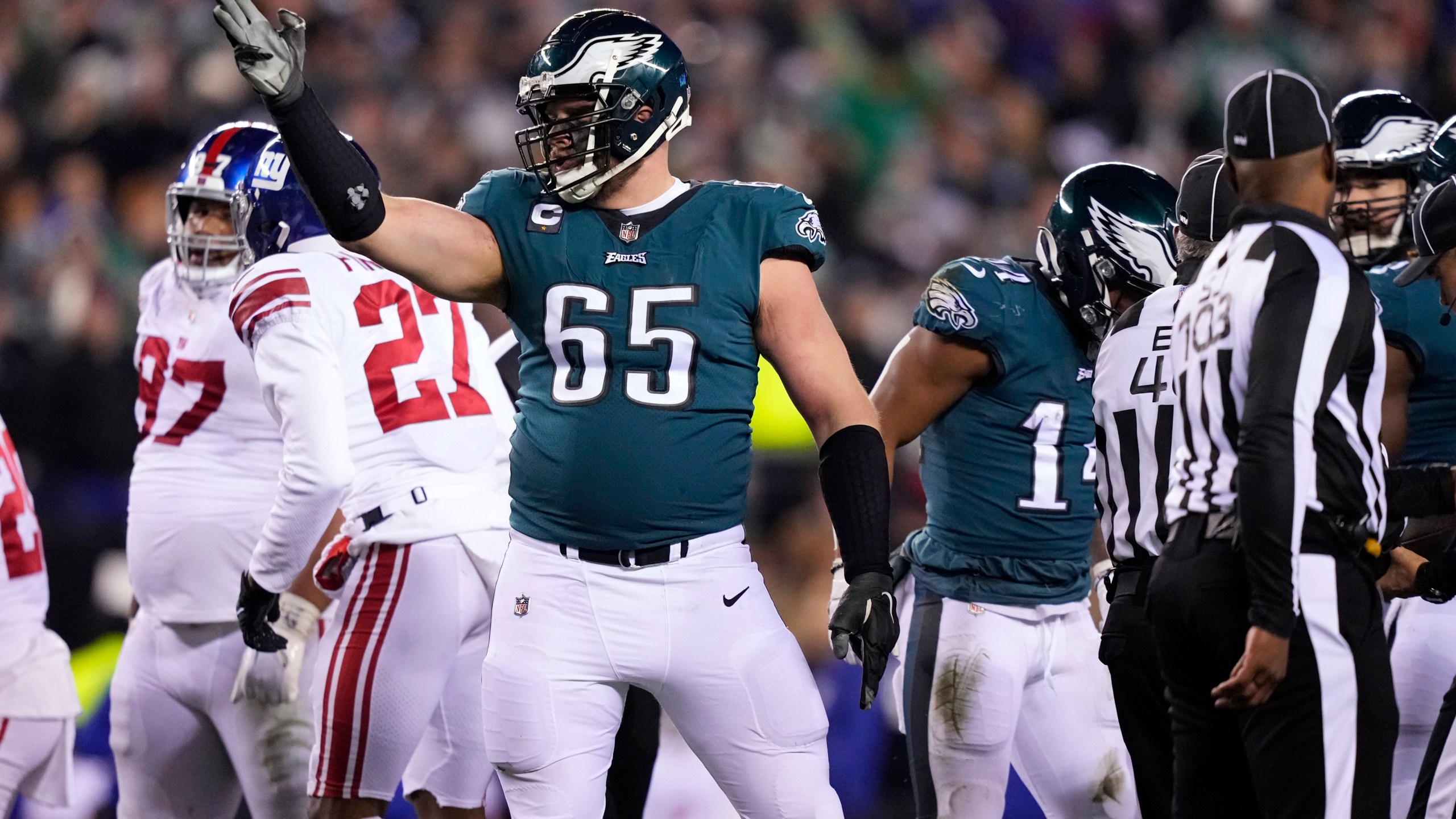 FILE - Philadelphia Eagles offensive tackle Lane Johnson (65) reacts after running back Kenneth Gainwell (14) rushed for a first down against the New York Giants during the second half of an NFL divisional round playoff football game Jan. 21, 2023, in Philadelphia. Johnson sets the standard on the right side of the line. (AP Photo/Matt Slocum, File)