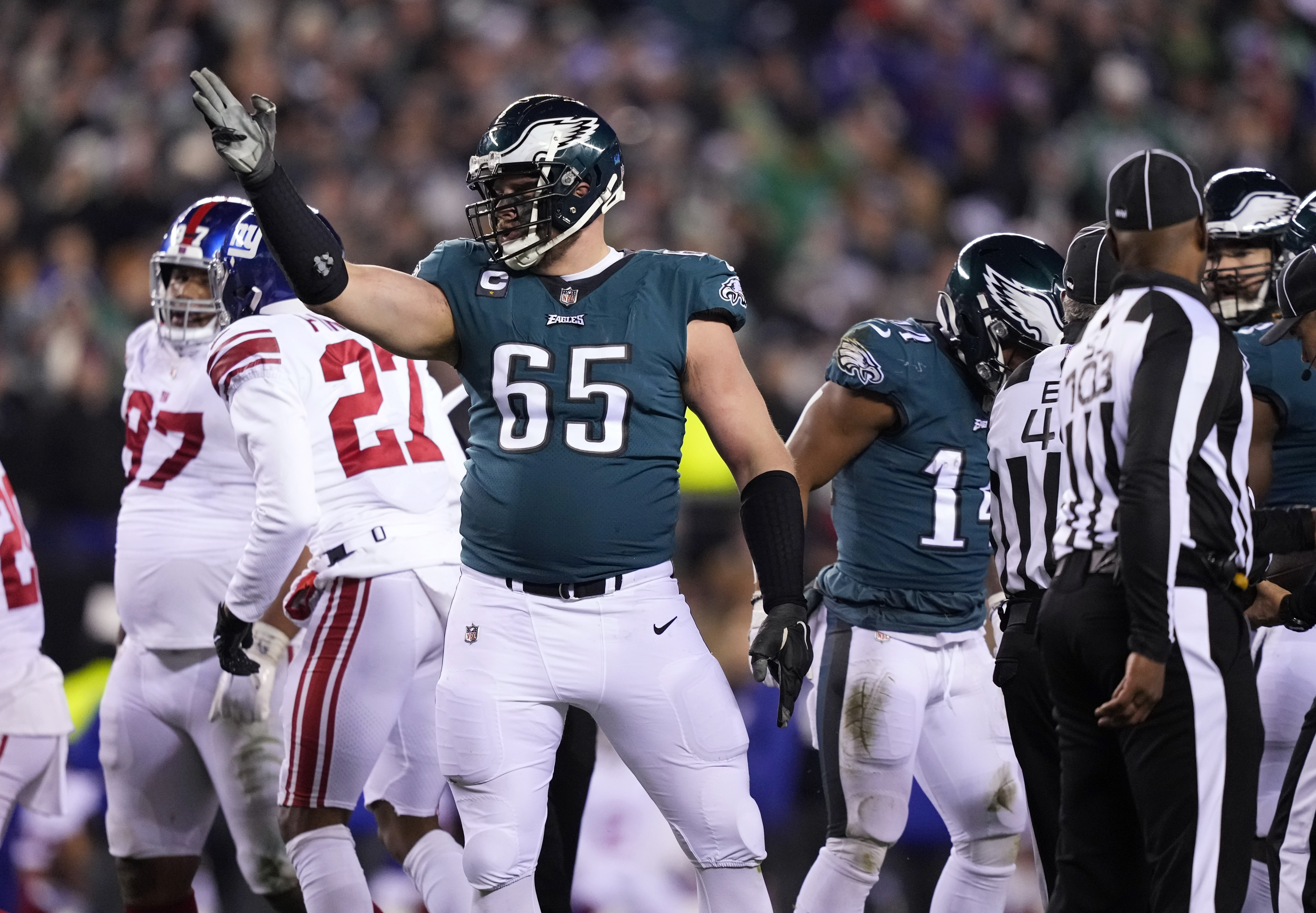 FILE - Philadelphia Eagles offensive tackle Lane Johnson (65) reacts after running back Kenneth Gainwell (14) rushed for a first down against the New York Giants during the second half of an NFL divisional round playoff football game Jan. 21, 2023, in Philadelphia. Johnson sets the standard on the right side of the line. (AP Photo/Matt Slocum, File)