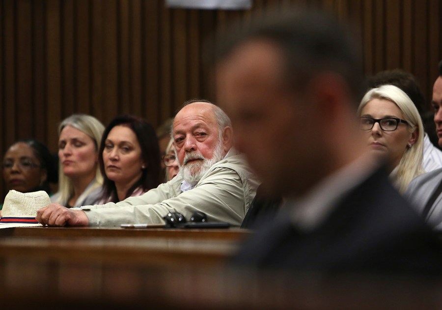 FILE - Barry Steenkamp, back centre, father of Reeva Steenkamp, eyes Oscar Pistorius, foreground, in the High Court in Pretoria, South Africa, Wednesday, June 15, 2016. A family spokesperson says Barry Steenkamp, the father of Reeva Steenkamp, the woman who was fatally shot by Olympic runner Oscar Pistorius, has died. He was 80. Family lawyer and spokesperson Tania Koen confirmed Barry Steenkamp’s death to The Associated Press on Friday, Sept. 15, 2023. (Alon Skuy, Pool Photo via AP, File)