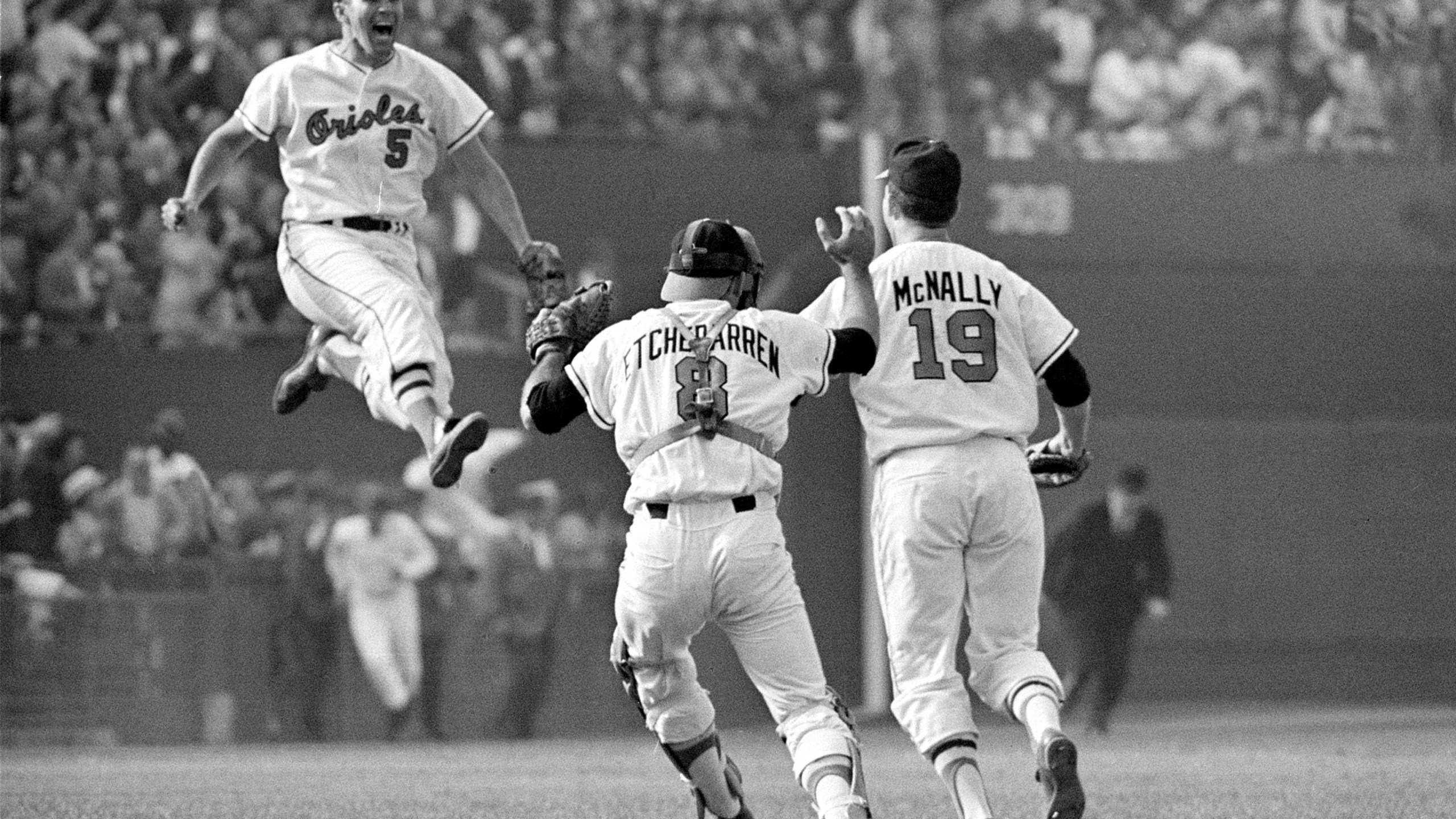 FILE - Baltimore Orioles third baseman Brooks Robinson (5) leaps across the infield to congratulate pitcher Dave McNally (19) and Orioles catcher Andy Etchebarren (8) after the final out in a World Series baseball game against the Los Angeles Dodgers in Baltimore, Md., on Oct. 9, 1966. Robinson, whose deft glovework and folksy manner made him one of the most beloved and accomplished athletes in Baltimore history, has died, according to a joint announcement by the Orioles and his family Tuesday, Sept. 26, 2023. (AP Photo/Bob Daugherty, File)