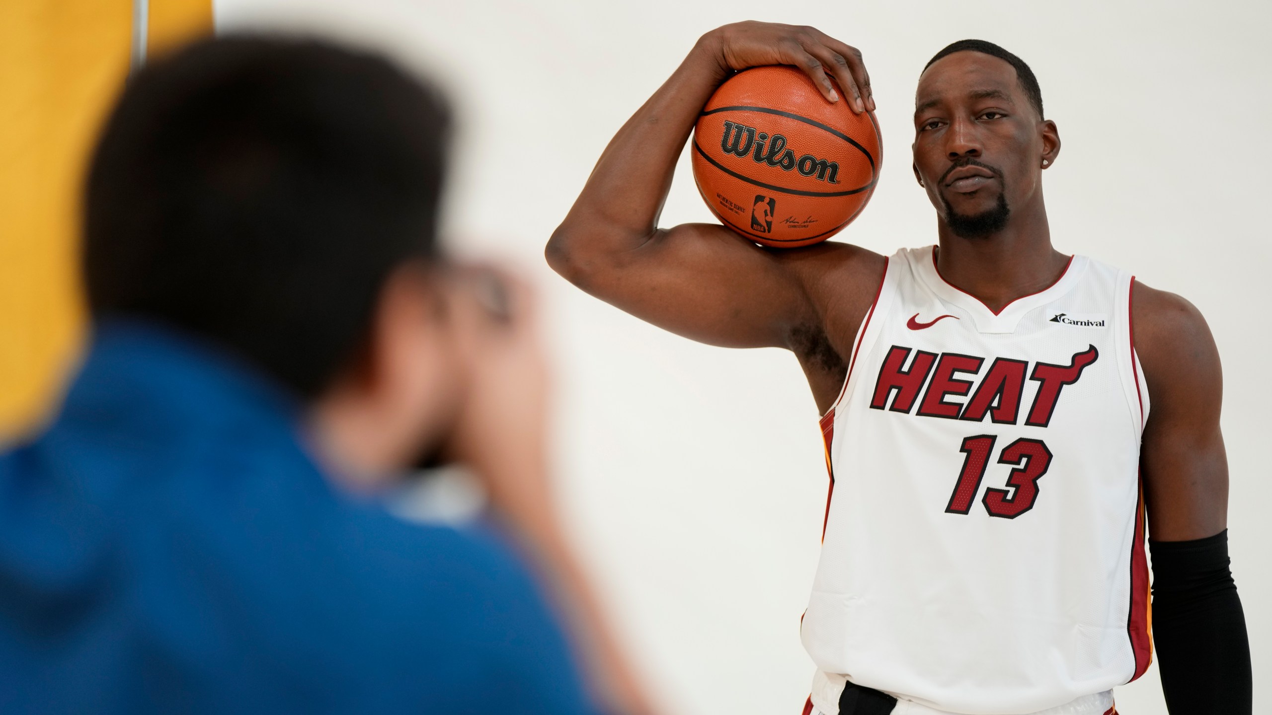 Miami Heat center Bam Adebayo (13) poses for portraits with a news photographer during the NBA basketball team's media day, in Miami, Monday, Oct. 2, 2023. (AP Photo/Rebecca Blackwell)