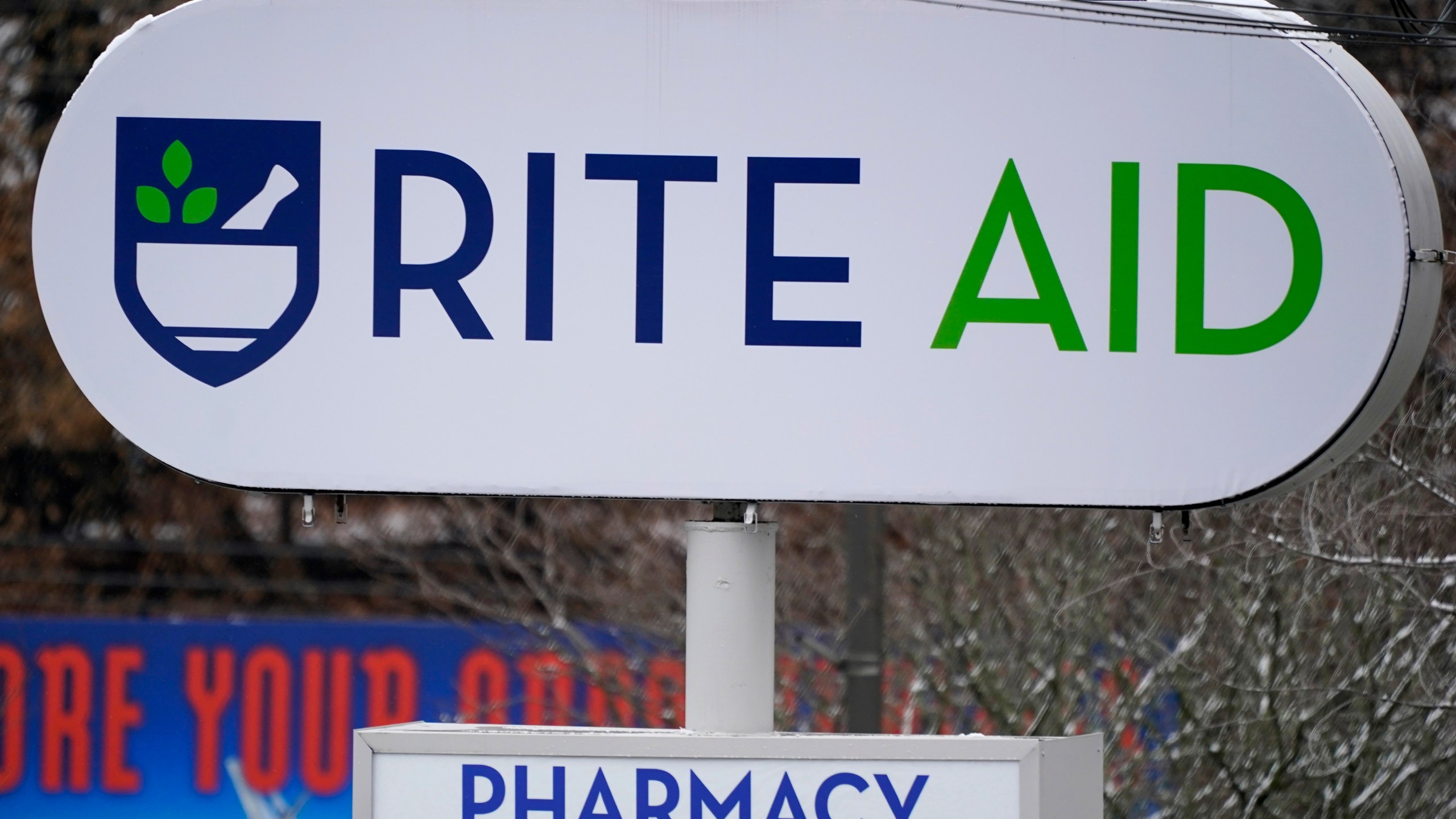 A Rite Aid sign stands in front of one of the drugstore's locations in Pittsburgh on Monday, Jan. 23, 2023. Rite Aid’s plan to close more stores as part of its bankruptcy process raises concern about how that might hurt access to medicine and care. The drugstore chain said late Sunday, Oct. 15, that its voluntary Chapter 11 process will allow it to speed up its plan to close underperforming stores. (AP Photo/Gene J. Puskar)