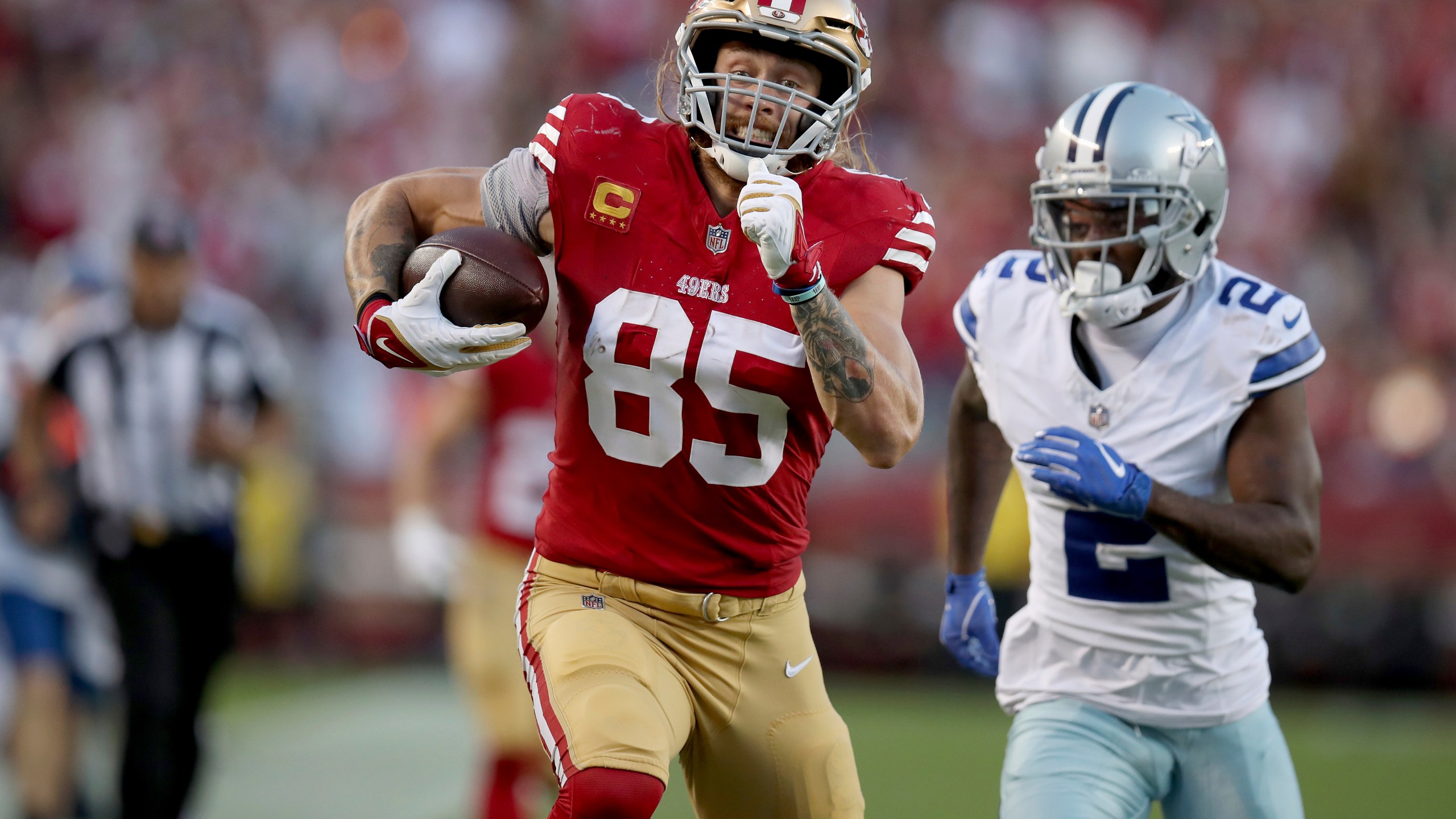 FILE - San Francisco 49ers tight end George Kittle (85) runs for a TD during an NFL football game against the Dallas Cowboys, Sunday, Oct 8, 2023, in Santa Clara, Calif. Kittle was voted one of the top tight ends at the midpoint of the season by The Associated Press.(AP Photo/Scot Tucker, File)