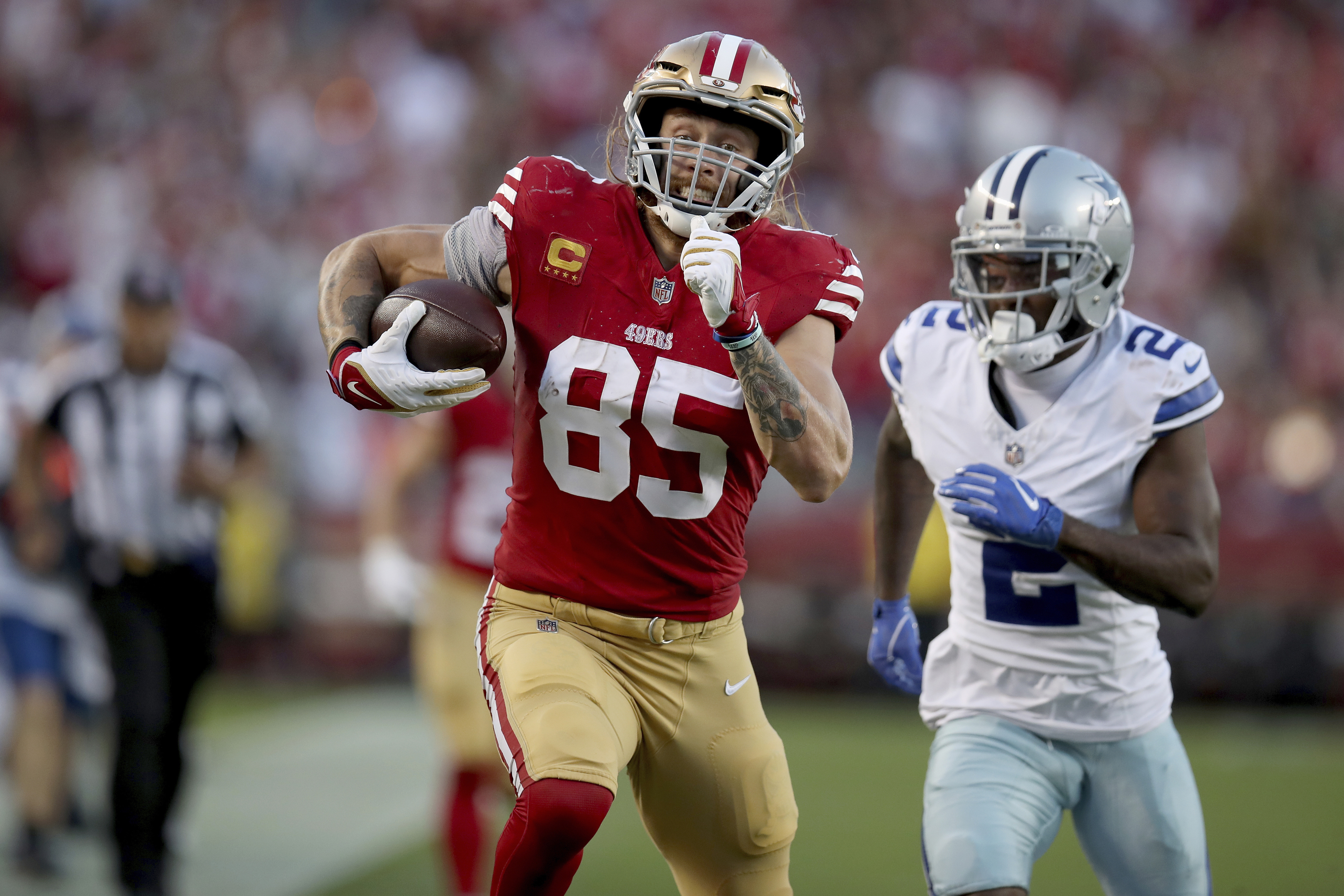 FILE - San Francisco 49ers tight end George Kittle (85) runs for a TD during an NFL football game against the Dallas Cowboys, Sunday, Oct 8, 2023, in Santa Clara, Calif. Kittle was voted one of the top tight ends at the midpoint of the season by The Associated Press.(AP Photo/Scot Tucker, File)