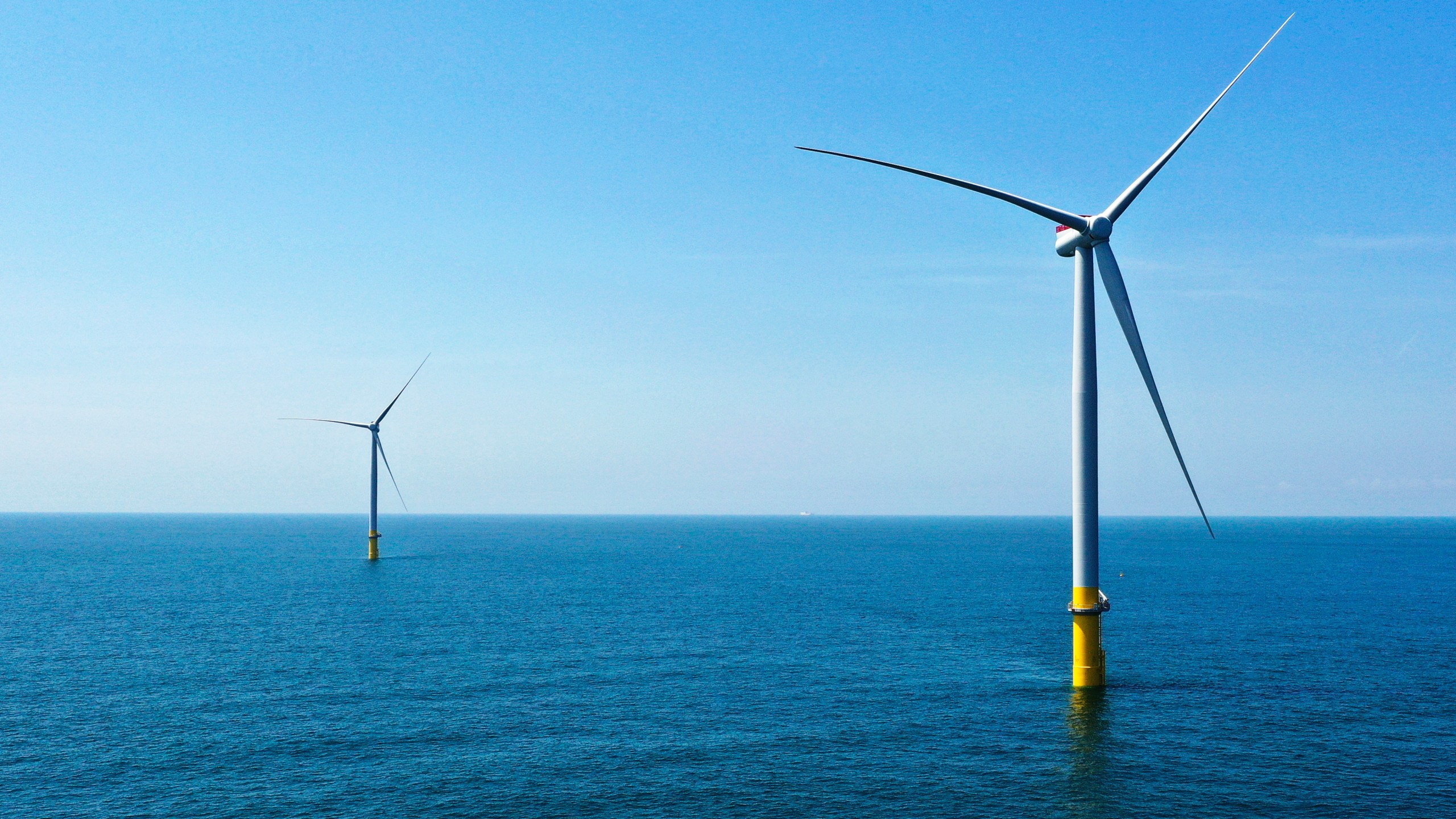 FILE - Two of the offshore wind turbines stand off the coast of Virginia Beach, Va., Monday, June 29, 2020. The company Siemens Gamesa said Friday Nov. 10, 2023, that it canceled plans to build blades for offshore wind turbines in coastal Virginia. It was the latest sign of struggle within the U.S.'s nascent offshore wind industry. (AP Photo/Steve Helber, File)