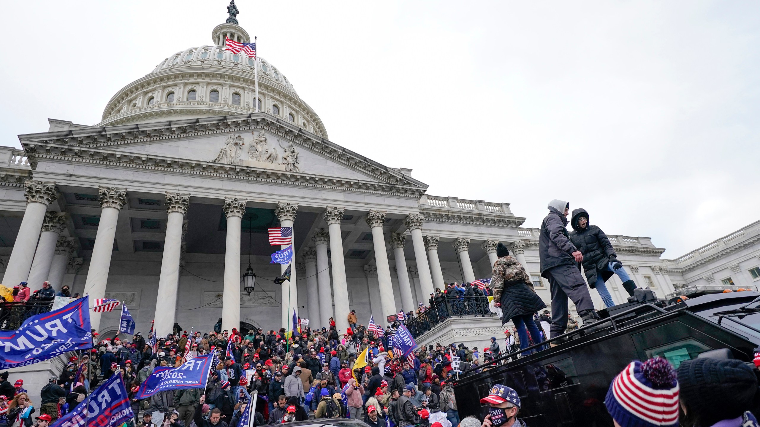 FILE - Rioters loyal to President Donald Trump stand on vehicles and the steps of the U.S. Capitol on Jan. 6, 2021, in Washington. Jason Donner, a former Fox News producer says in a lawsuit filed Monday, Nov. 13, 2023, he was targeted and fired for pushing back against false claims about the riot at the U.S. Capitol on Jan. 6. Donner said he was part of a “purge” of employees who refused to report information that would please Trump and his supporters. Donner was inside the Capitol during the riot and pressed his complaints about the networks coverage for months(AP Photo/Julio Cortez, File)