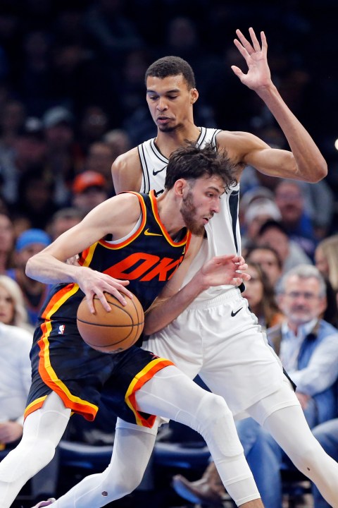 Oklahoma City forward Chet Holmgren, left, dribbles as San Antonio center Victor Wembanyama defends during the first half of an NBA in-season tournament basketball game Tuesday, Nov. 14, 2023, in Oklahoma City. (AP Photo/Nate Billings)