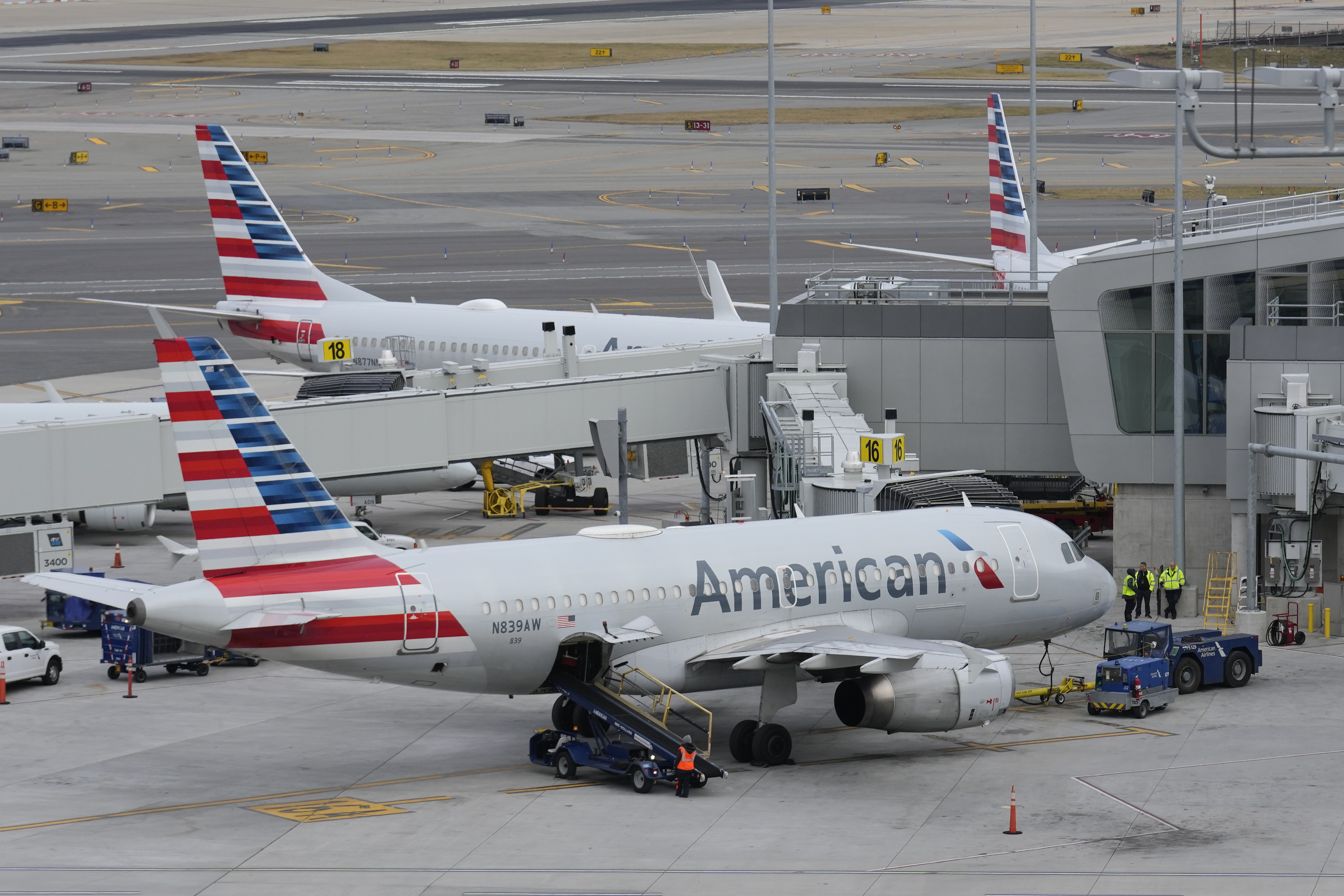 FILE - American Airlines planes sit on the tarmac at Terminal B at LaGuardia Airport, Jan. 11, 2023, in New York. American Airlines flight attendants are asking federal officials for the right to go on strike, possibly before the end of the Christmas and New Year's travel rush, but the airline said there was “no possibility” of a walkout over the holidays. The Association of Professional Flight Attendants petitioned the National Mediation Board on Monday, Nov. 20, to declare the negotiations deadlocked and give the union permission to strike after a 30-day “cooling-off period.” (AP Photo/Seth Wenig, File)