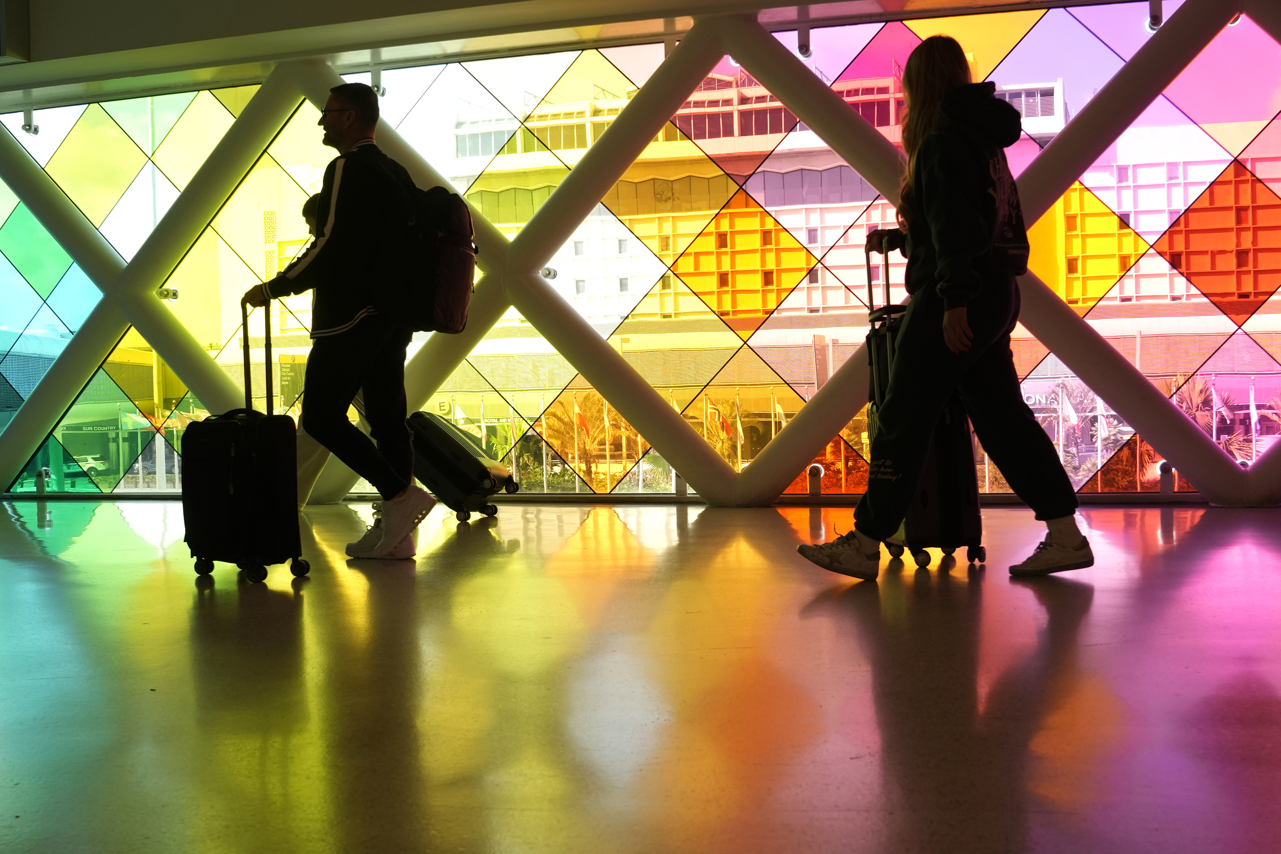 FILE - Travelers walk through Miami International Airport ahead of the Thanksgiving holiday, Wednesday, Nov. 22, 2023, in Miami. A record number of passengers traveled through U.S. airports over Thanksgiving weekend, the Transportation Security Administration said Monday, Nov. 27. (AP Photo/Lynne Sladky, File)