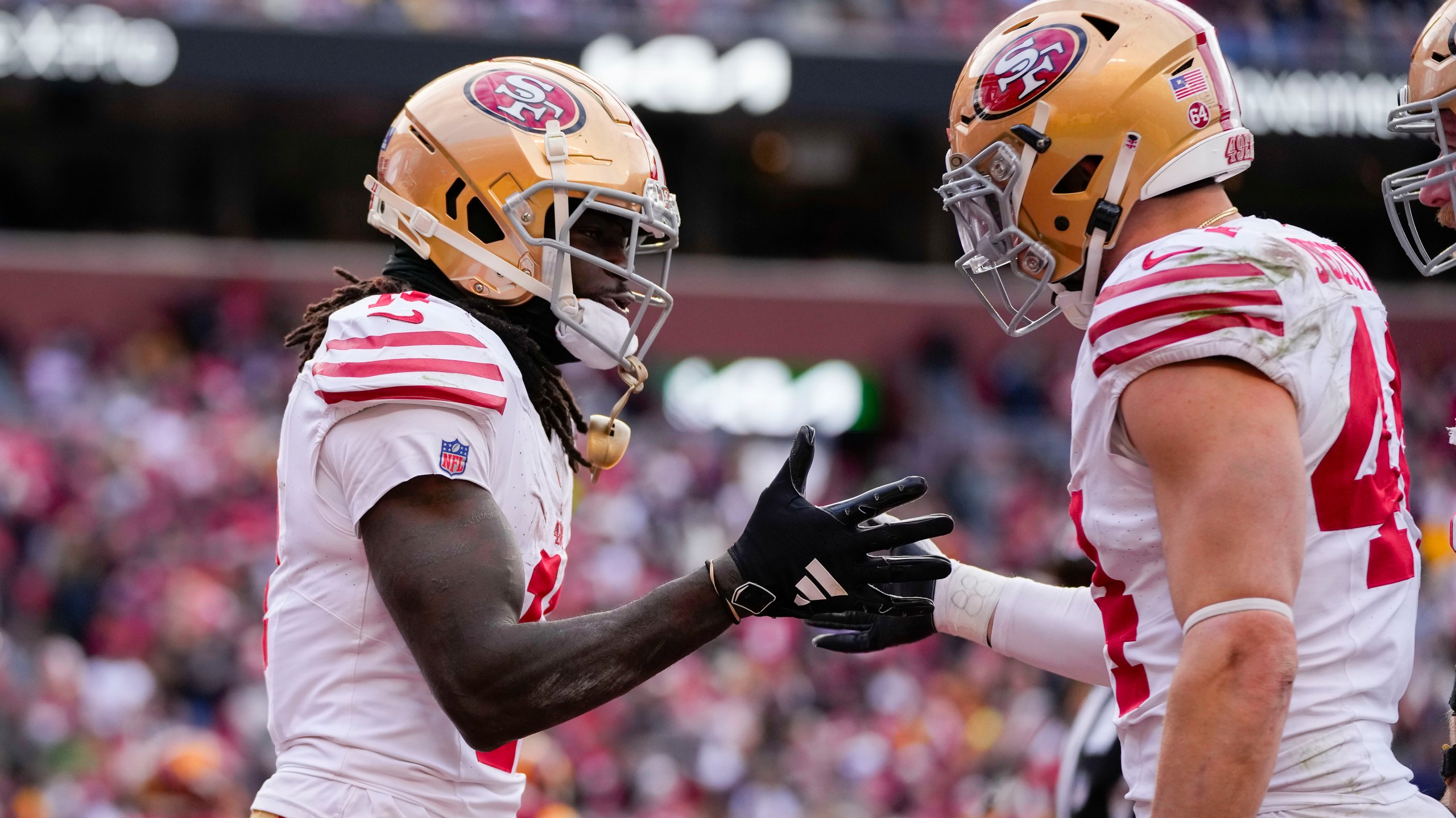 San Francisco 49ers wide receiver Brandon Aiyuk (11) celebrates his touchdown with teammate fullback Kyle Juszczyk (44) during the second half of an NFL football game against the Washington Commanders, Sunday, Dec. 31, 2023, in Landover, Md. (AP Photo/Alex Brandon)