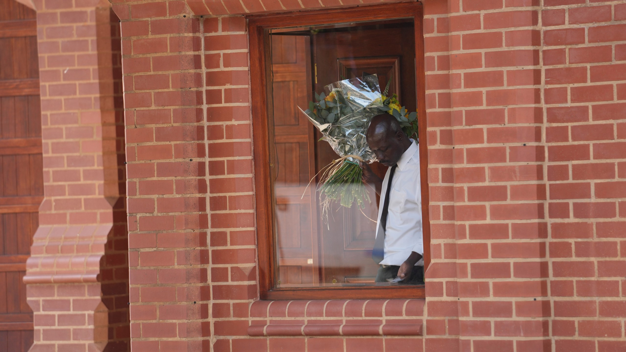 Flowers are delivered to the home of Oscar Pistorius' uncle in the upmarket suburb of Waterkloof, Pretoria, South Africa, Friday, Jan. 5, 2024. South African athlete Pistorius has been released from prison on parole after serving nearly nine years in prison for killing his girlfriend Reeva Steenkamp on Valentine's Day in 2013 .(AP Photo/Tsvangirayi Mukwazhi)