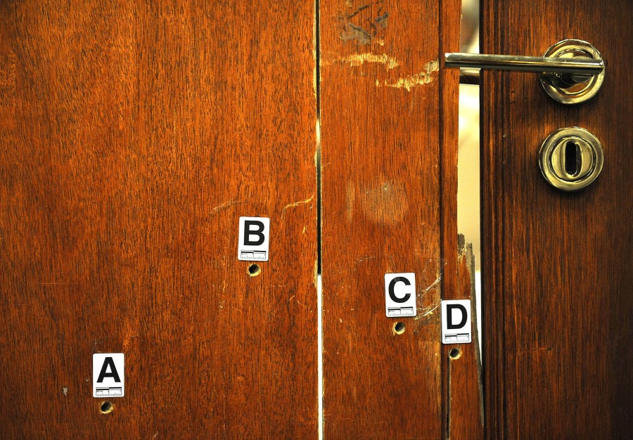 FILE — The bullet-riddled toilet door through which Oscar Pistorius shot and killed his girlfriend Reeva Sttenkamp is exhibited in court in Pretoria, South Africa, Monday, April 14, 2014. Pistorius shot his girlfriend Reeva Steenkamp more than a decade ago in a Valentine's Day killing that jolted the world and shattered the image of a sports superstar. (AP Photo/Antoine de Ras, Pool, File)