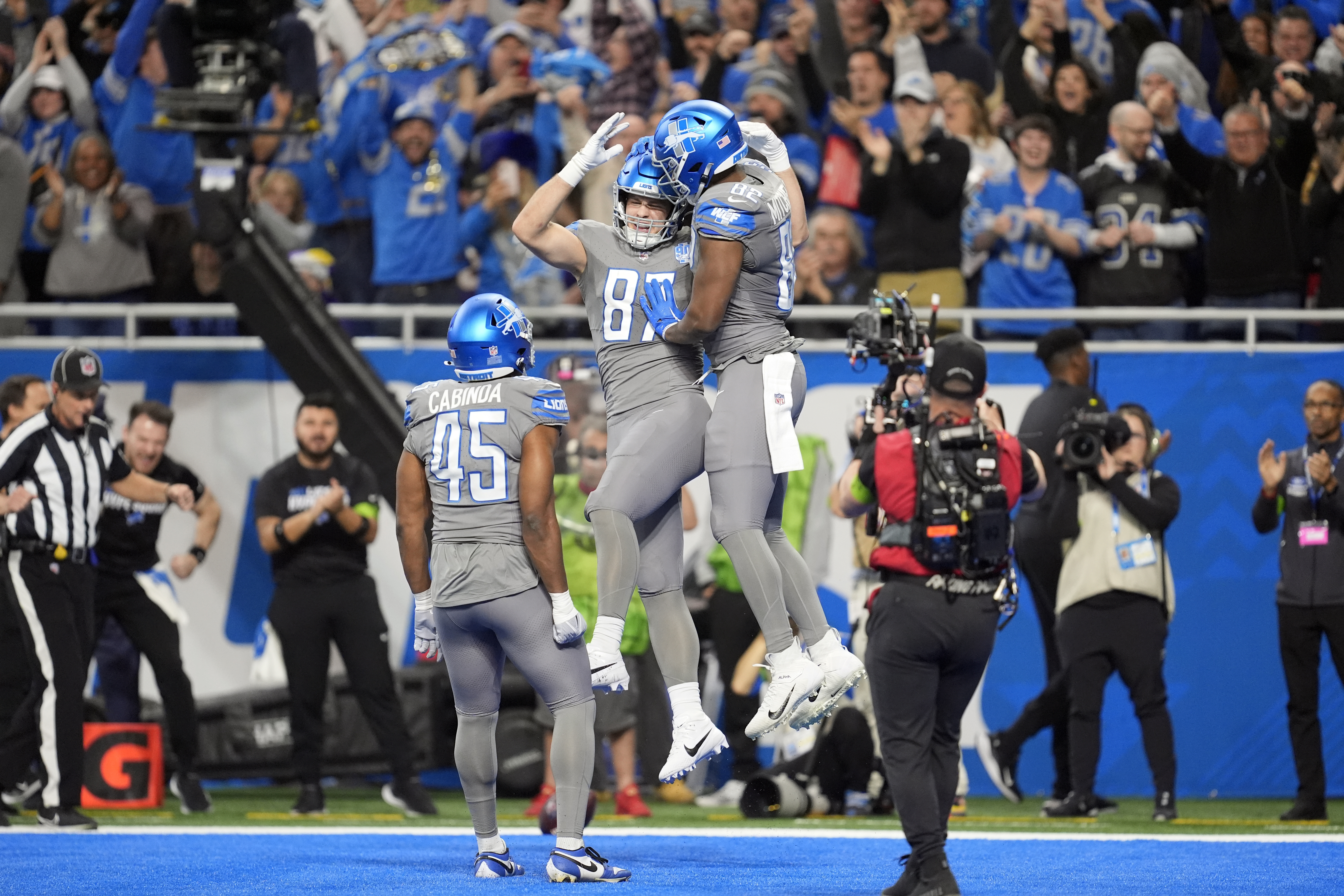 Detroit Lions tight end Sam LaPorta (87) is congrautalted by tight end James Mitchell (82) after LaPorta's 2-yard touchdown reception during the first half of an NFL football game against the Minnesota Vikings, Sunday, Jan. 7, 2024, in Detroit. (AP Photo/Paul Sancya)