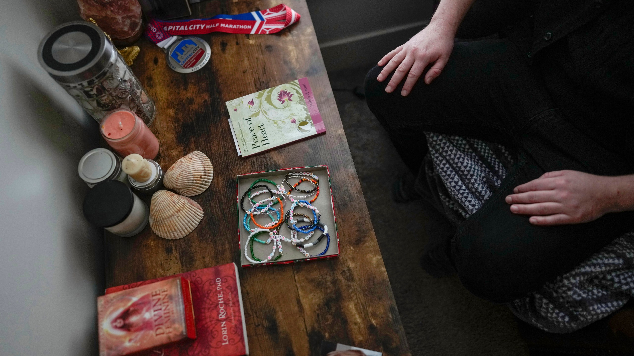 Ashton Colby's meditation corner has meaningful objects, including an image before he transitioned, in his apartment in Columbus, Ohio, on Thursday, Jan. 18, 2024. Ohio Gov. Mike DeWine announced proposals this month that transgender advocates say could block access to gender-affirming care provided by independent clinics and general practitioners, leaving thousands of adults scrambling for treatment and facing health risks. Colby, 31, fears the clinic where he gets the testosterone he has taken since age 19 would no longer offer it. (AP Photo/Carolyn Kaster)