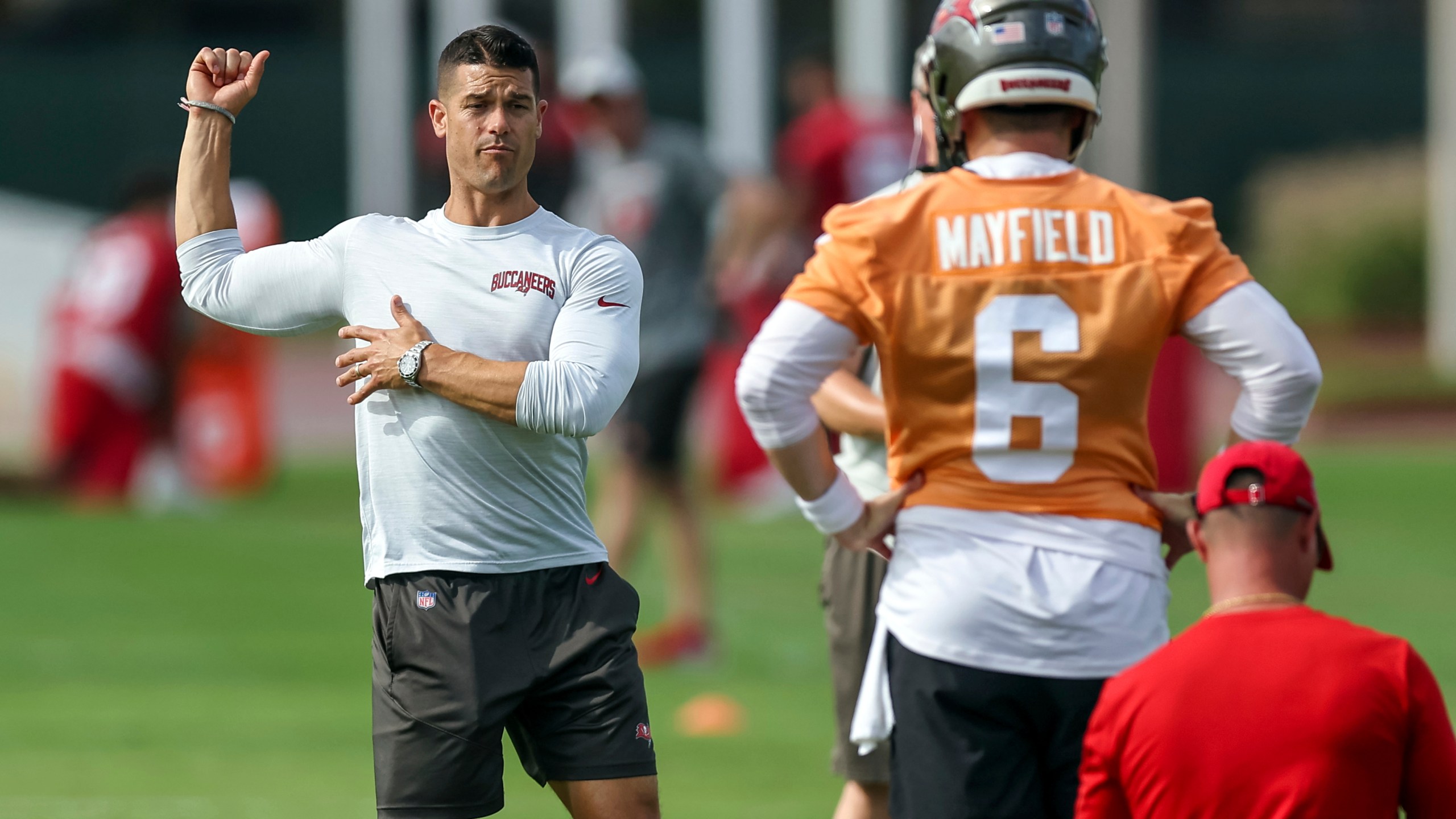 FILE - Tampa Bay Buccaneers offensive coordinator Dave Canales, left, talks with quarterback Baker Mayfield during NFL football practice Tuesday, June 13, 2023, in Tampa, Fla. The Carolina Panthers have agreed to hire Tampa Bay Buccaneers offensive coordinator Dave Canales as their new head coach, according to two people familiar with the situation. (AP Photo/Mike Carlson, File)