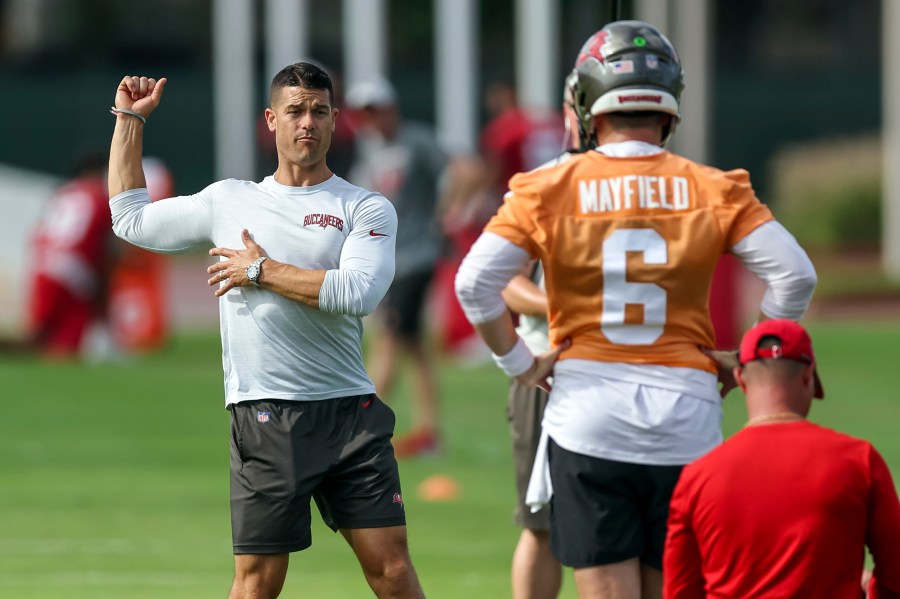 FILE - Tampa Bay Buccaneers offensive coordinator Dave Canales, left, talks with quarterback Baker Mayfield during NFL football practice Tuesday, June 13, 2023, in Tampa, Fla. The Carolina Panthers have agreed to hire Tampa Bay Buccaneers offensive coordinator Dave Canales as their new head coach, according to two people familiar with the situation. (AP Photo/Mike Carlson, File)