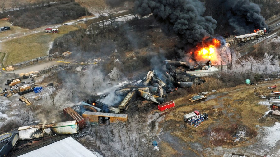 FILE - This photo taken with a drone shows portions of a Norfolk Southern freight train that derailed Feb. 3, in East Palestine, Ohio, are still on fire on Feb. 4, 2023. The major freight railroads all promised safety improvements after the fiery derailment in eastern Ohio one year ago, but they have yet to make a meaningful improvement in the safety statistics and efforts to reform the industry have stalled in Congress. (AP Photo/Gene J. Puskar, File)