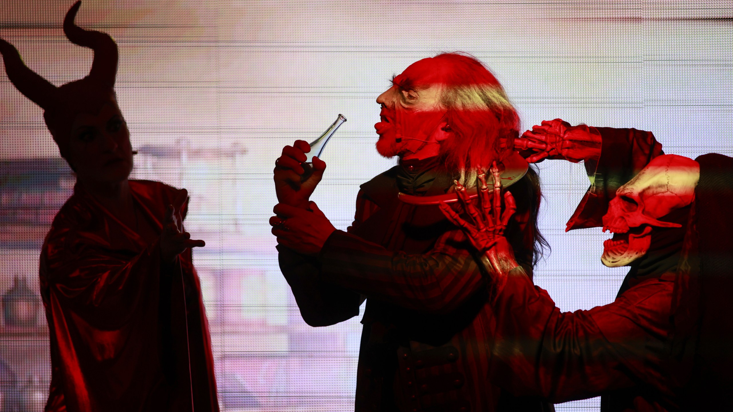 FILE - "Faust" actor Christian Venzke, center, stands next to Mephista actress Jessica Fendler, left, in a scene in Brocken, Germany, Friday, Nov. 3, 2023 .(Matthias Bein/dpa via AP, File)