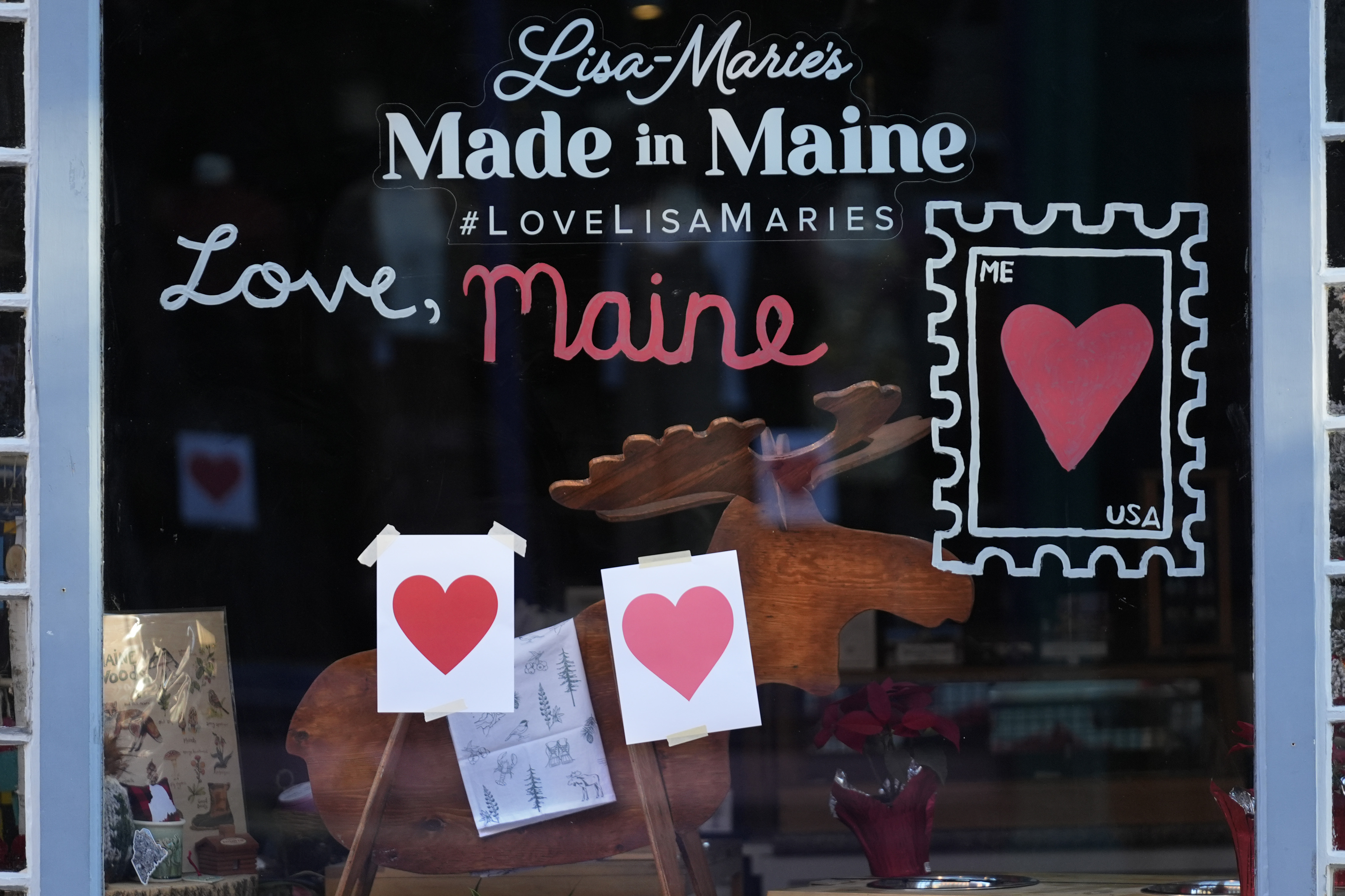 Valentine's Day hearts decorate a shop, Wednesday, Feb. 14, 2024, in Portland, Maine. The public has helped honor the memory of Kevin Fahrman, the Valentine's Day Bandit who secretly hung hundreds of red paper hearts throughout the city every February 14th. Farman died last year. (AP Photo/Robert F. Bukaty)