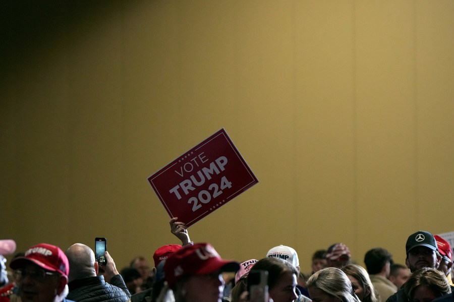 A supporters holds up a sign as Republican presidential candidate former President Donald Trump speaks at a campaign rally at Charleston Area Convention Center in North Charleston, S.C., Wednesday, Feb. 14, 2024. (AP Photo/David Yeazell)