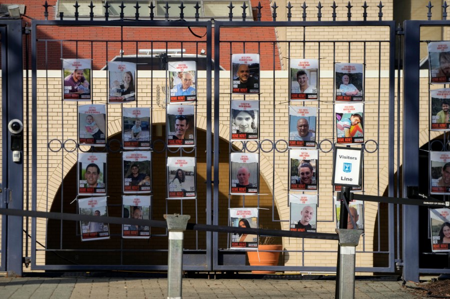 Posters of kidnapped people line the gates at the entrance of the Israeli Embassy, Monday, Feb. 26, 2024, in Washington. An active-duty member of the U.S. Air Force has died after he set himself ablaze outside the Israeli Embassy in Washington, D.C., while declaring that he "will no longer be complicit in genocide." (AP Photo/Mark Schiefelbein)