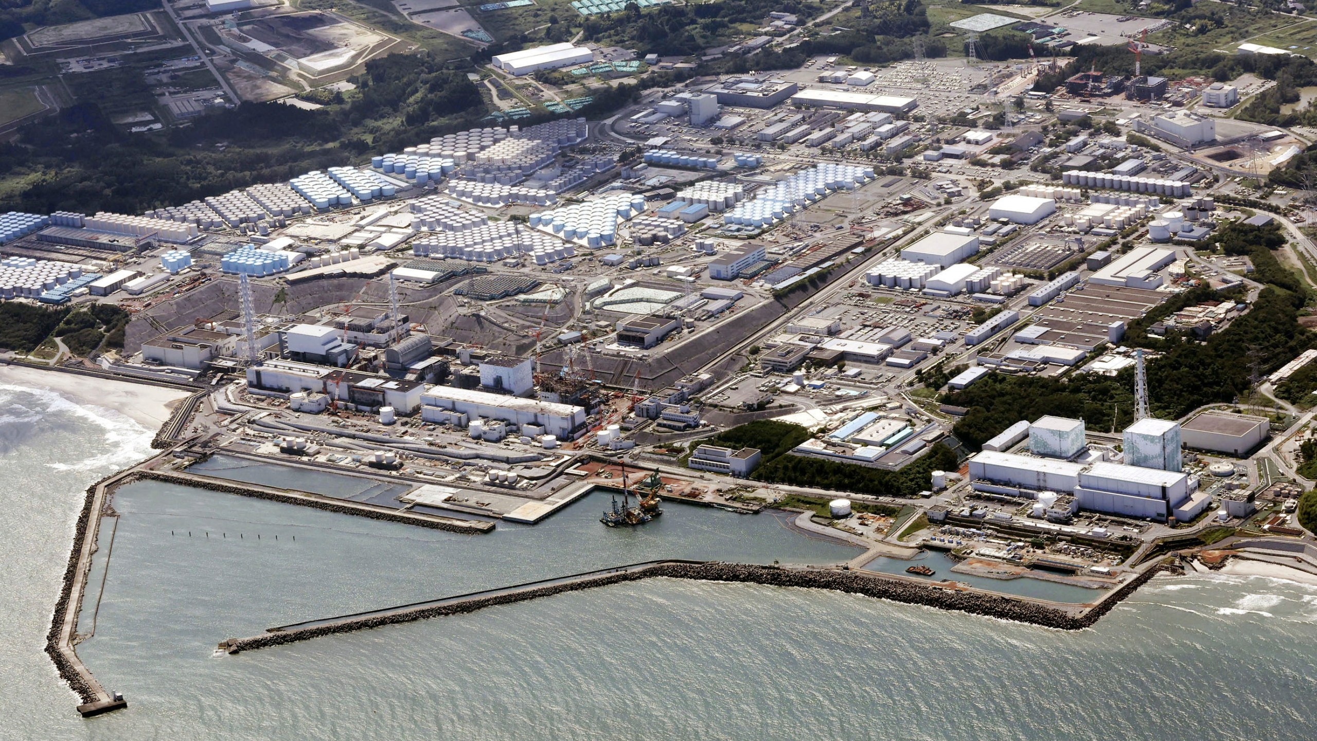 FILE - This aerial view shows the wrecked Fukushima Daiichi nuclear power plant in Okuma town, northeastern Japan, on Aug. 24, 2023. A drone small enough to fit in one's hand flew inside one of the damaged reactors at the wrecked nuclear power plant Wednesday, Feb. 28, 2024, in hopes it can examine some of the molten fuel debris in areas where earlier robots failed to reach. (Kyodo News via AP, File)