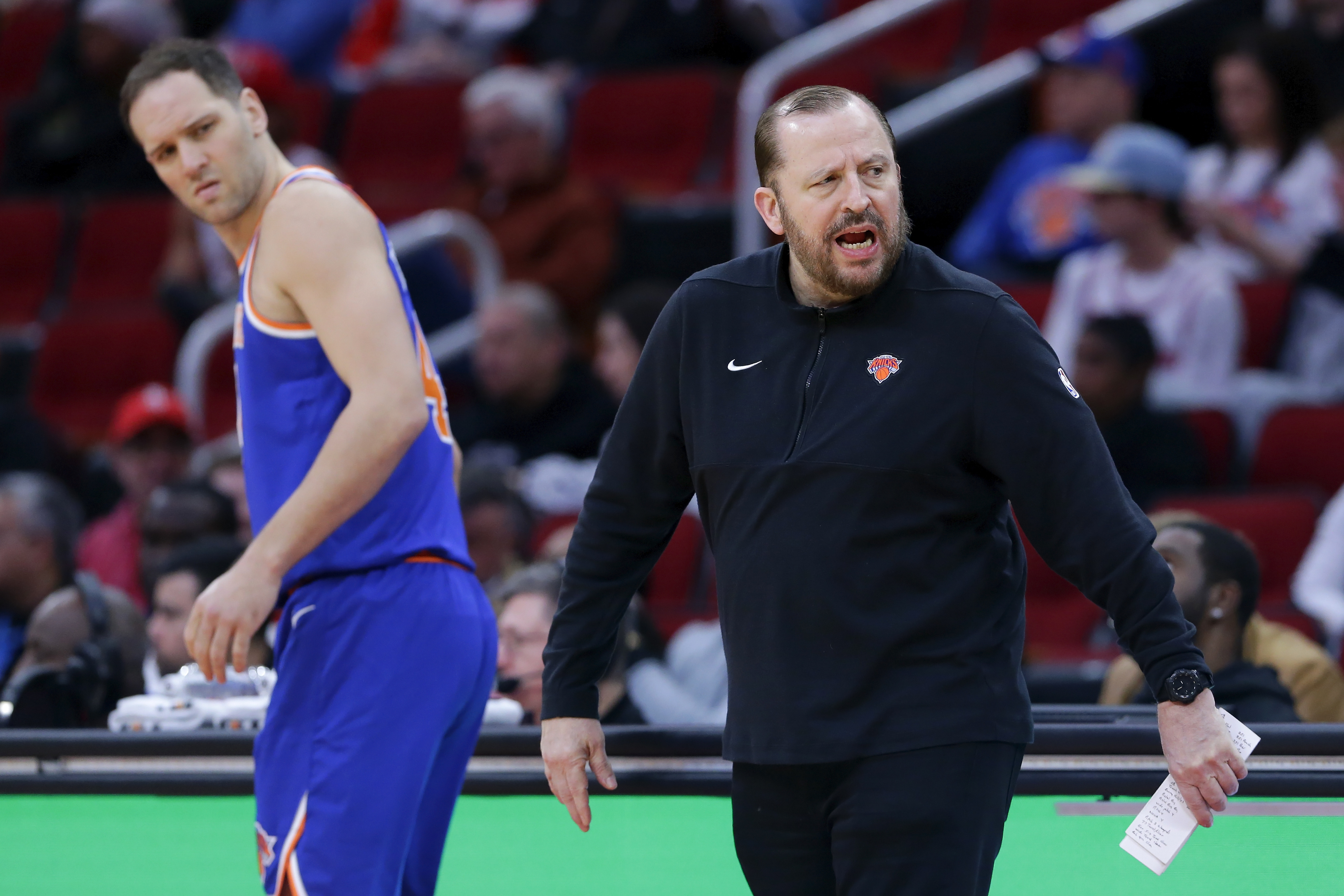 New York Knicks forward Bojan Bogdanovic, left, looks back as head coach Tom Thibodeau, right, protests a foul call during the first half of an NBA basketball game against the Houston Rockets, Monday, Feb. 12, 2024, in Houston. (AP Photo/Michael Wyke)