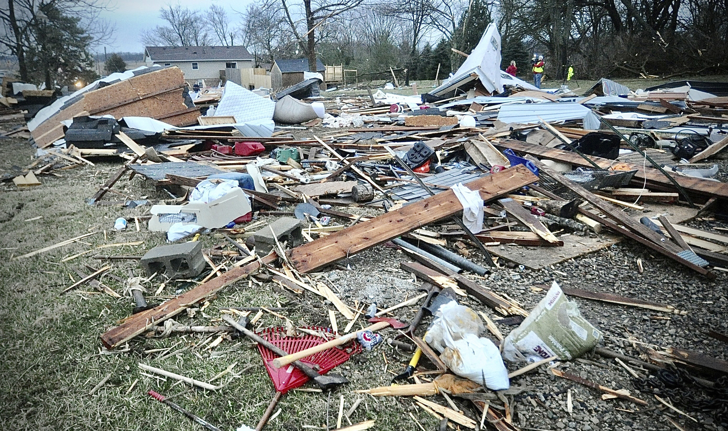 Debris of what used to be a pole barn covers a neighbor's backyard on Newlove Road following a severe storm near Springfield, Ohio, Wednesday morning, February 28, 2024. (Marshall Gorby/Dayton Daily News via AP)